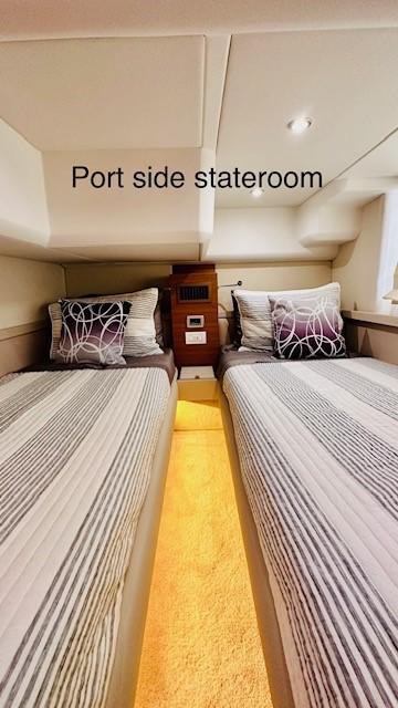 Port side stateroom in 2022 Greenline 48 Flybridge yacht with twin beds.