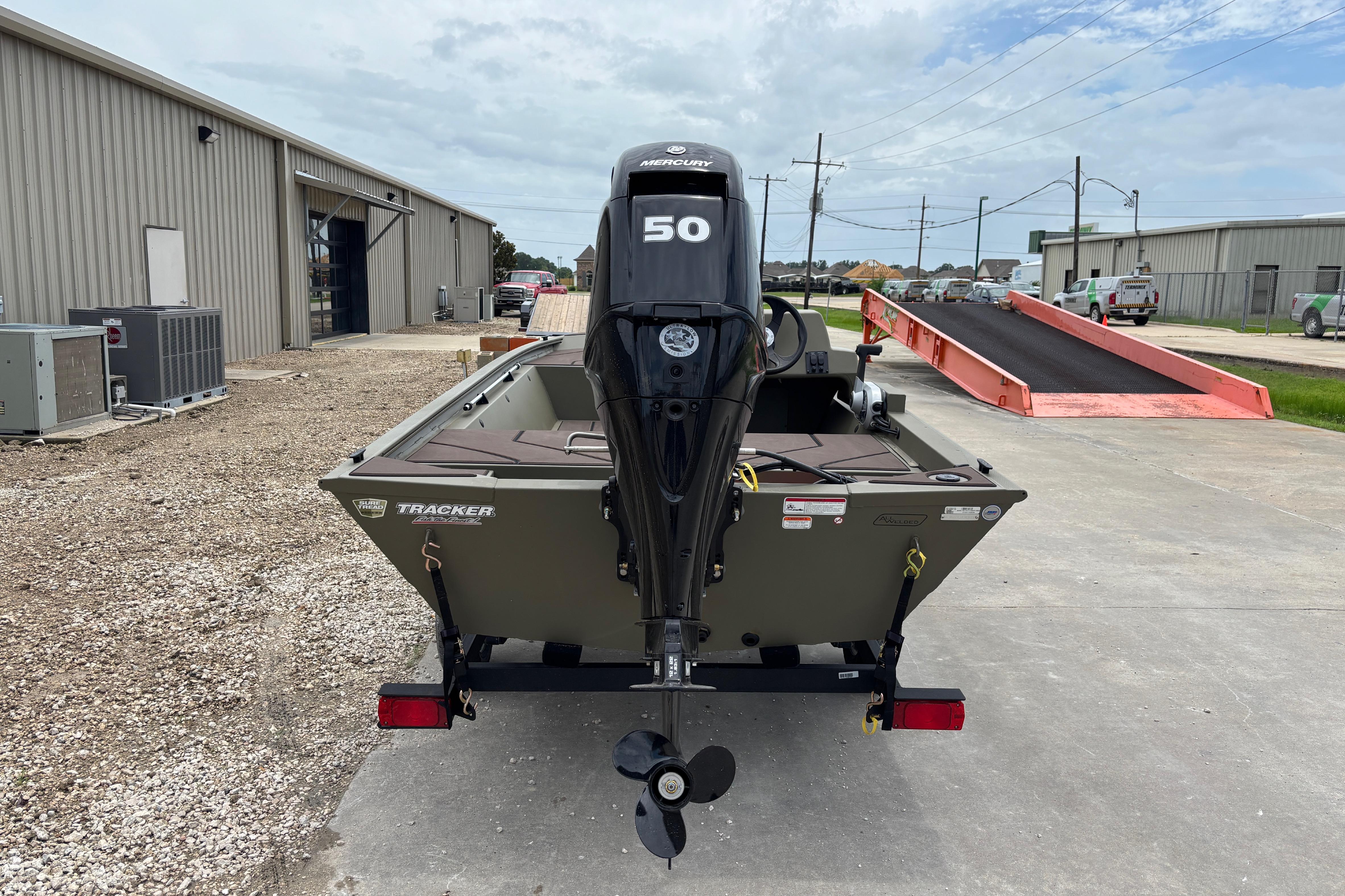 2026 Tracker Grizzly 1648 SC boat with Mercury 50 engine, parked outdoors.