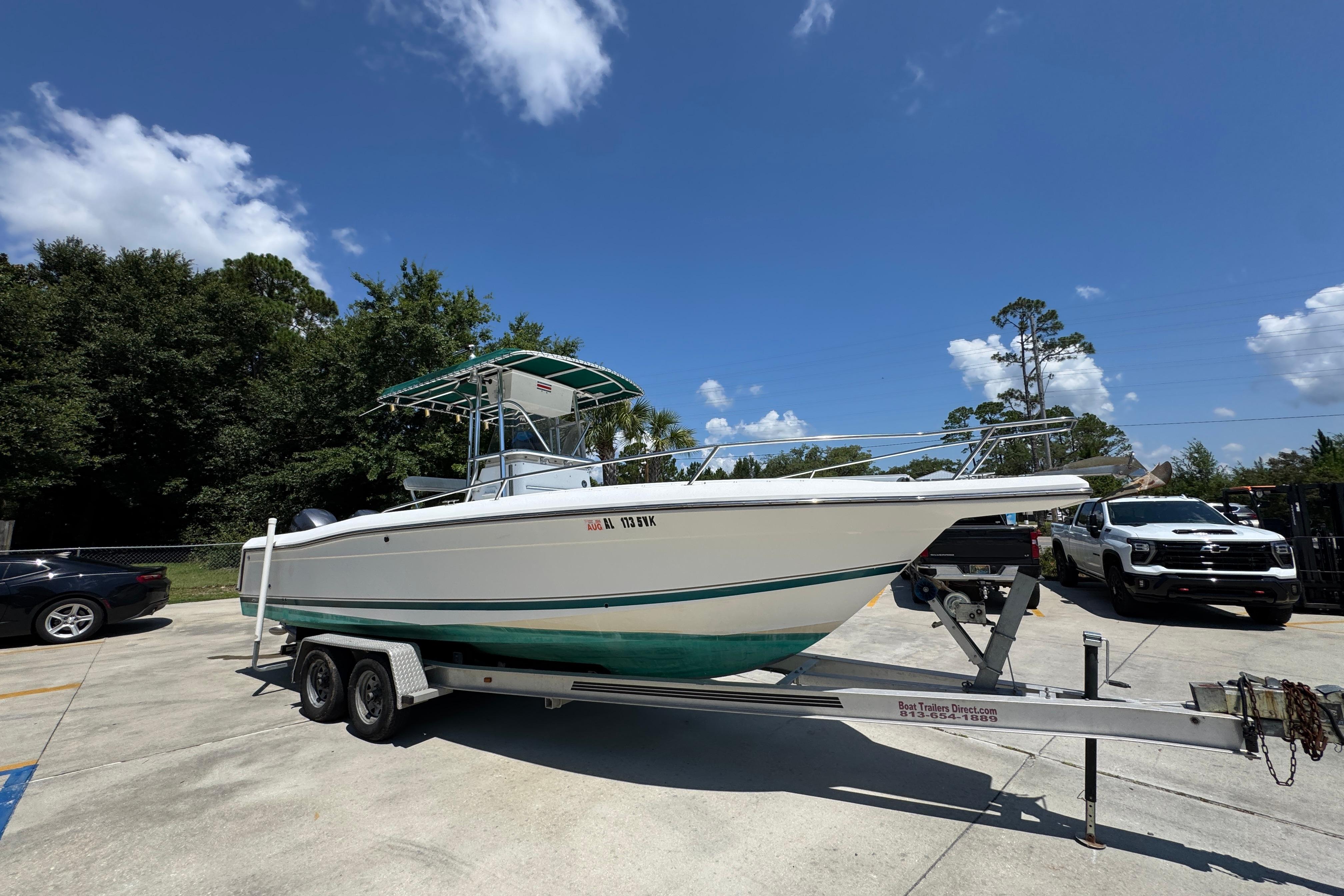 2000 Stamas 250 Tarpon boat on trailer under clear blue sky.
