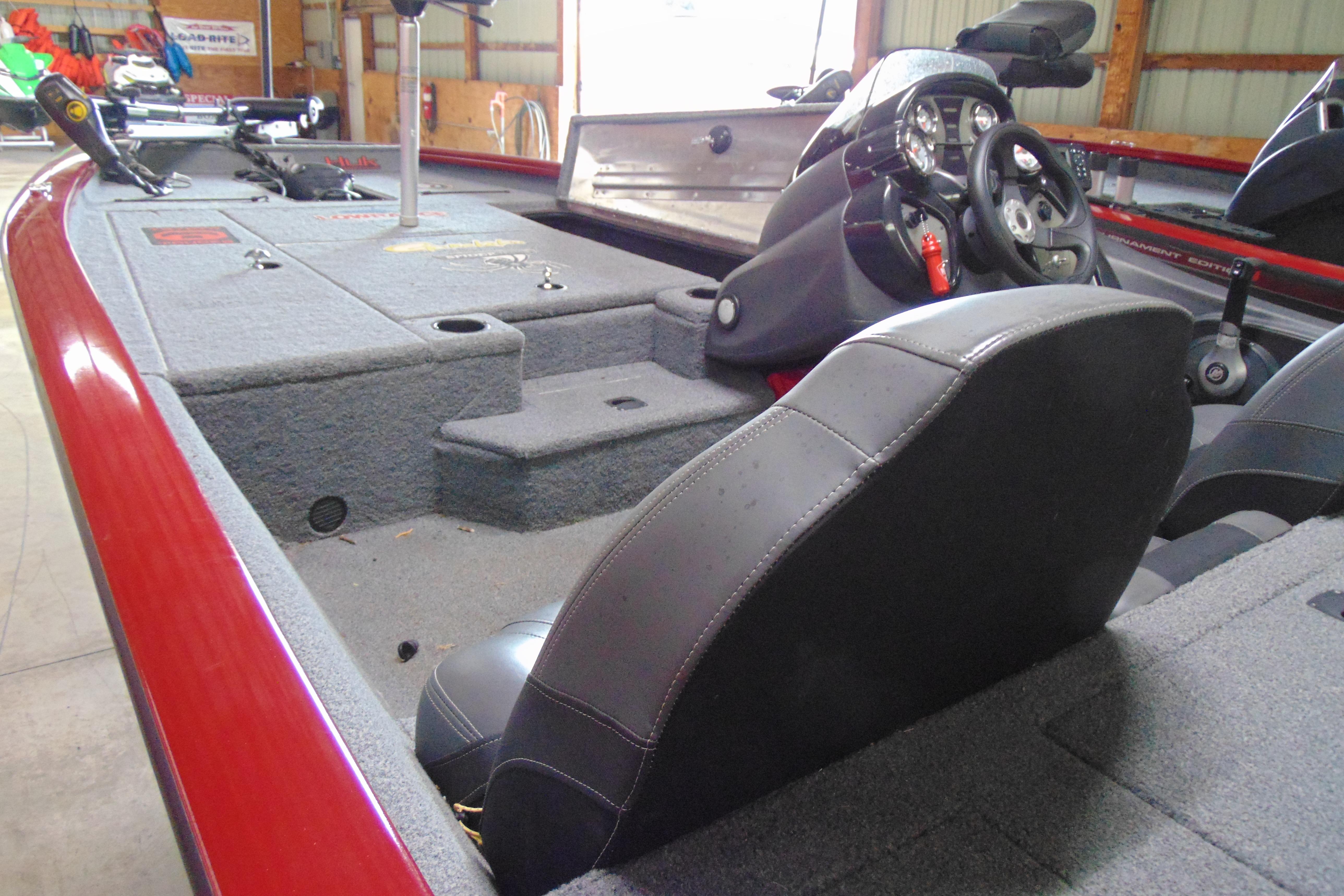 2022 Bass Tracker Pro 17 boat interior with steering console and seating in a garage.