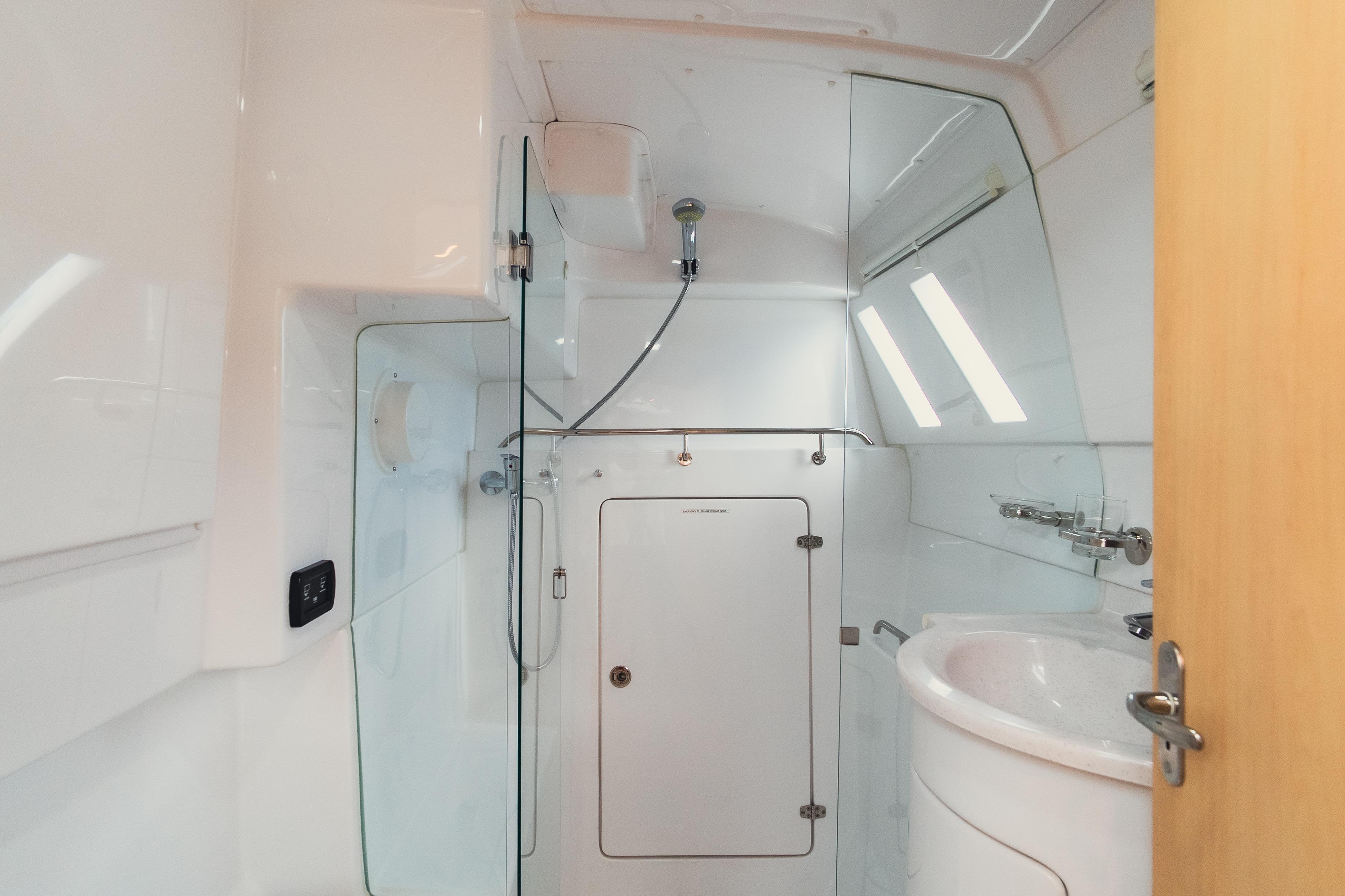 Modern bathroom in 2026 Seawind 1160XL yacht with sleek fixtures and glass shower.