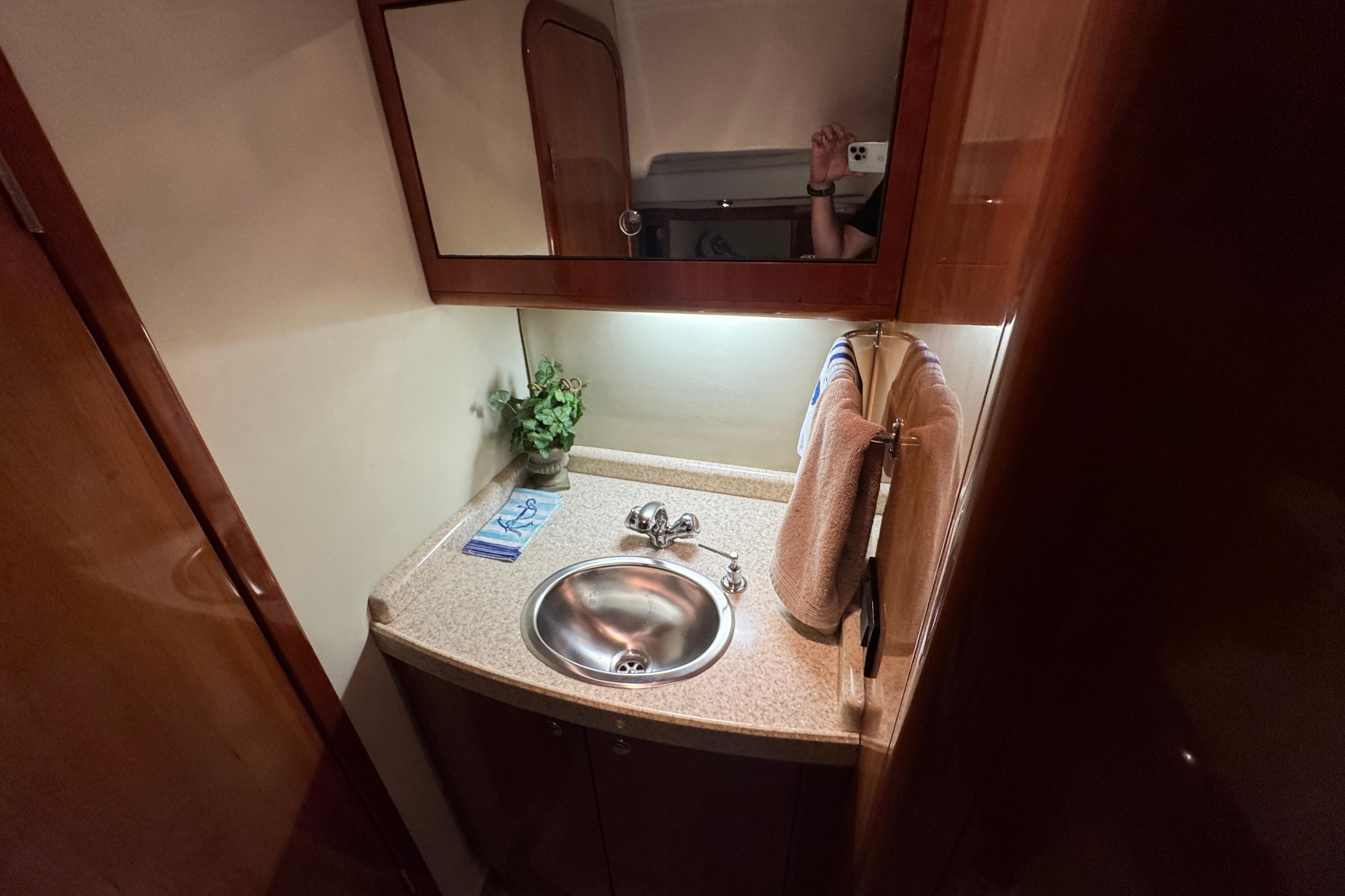 Luxurious bathroom in 2005 Regal Commodore 4260 yacht with elegant sink and mirror.
