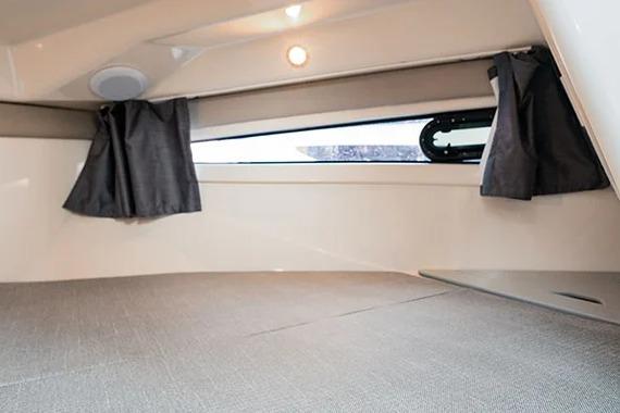 2026 Trophy T25EX EXPLORER OB cabin interior with window and curtains.