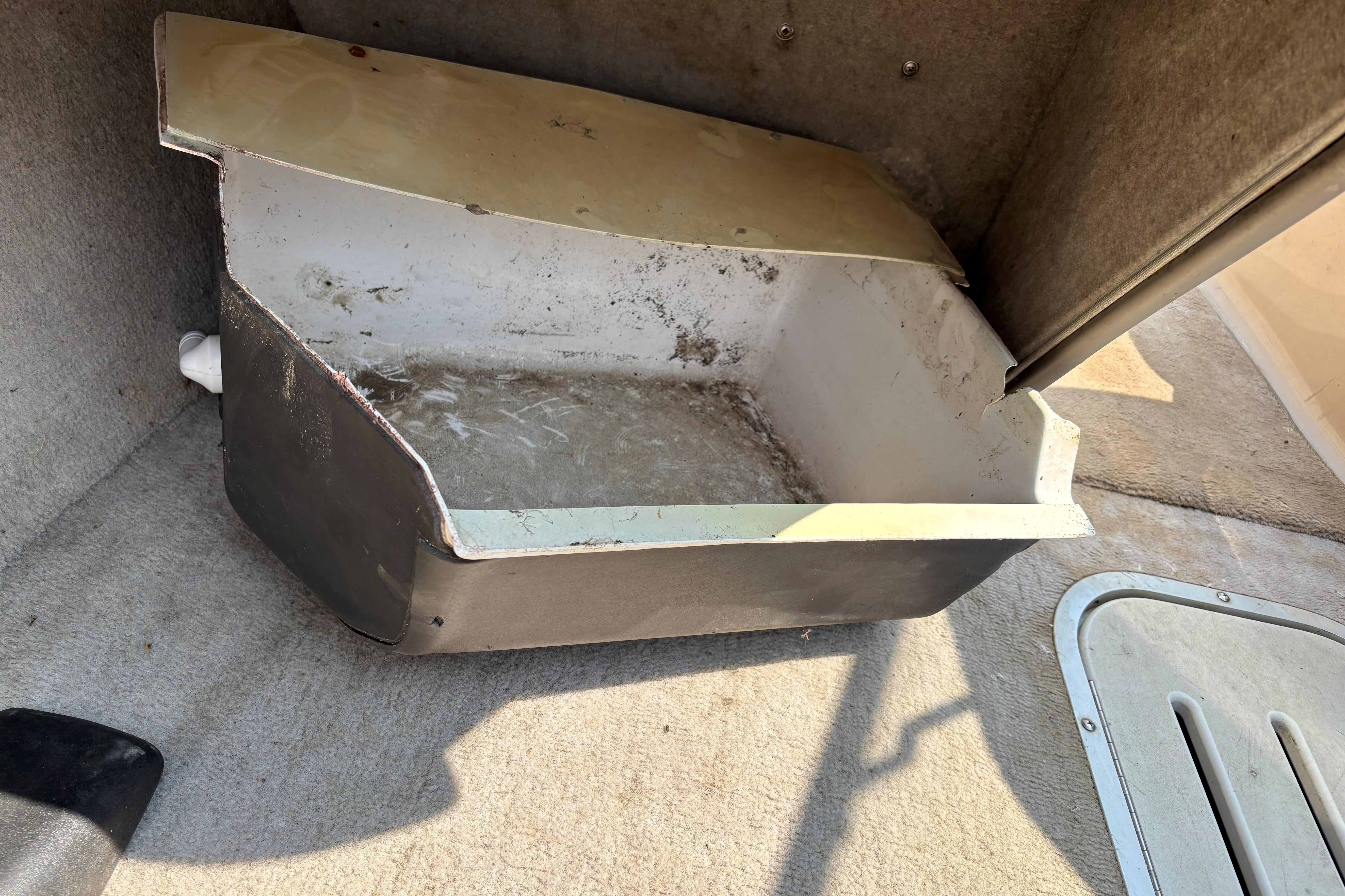 Old storage compartment in 2001 Crownline 18' boat interior.