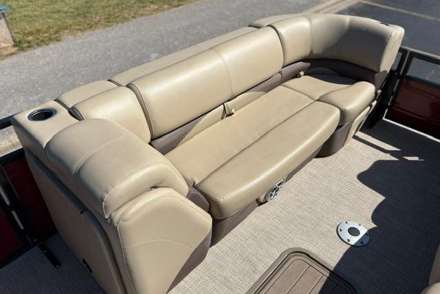Luxurious beige seating on 2025 Regency 250 DL3 pontoon boat, featuring cup holder and storage.