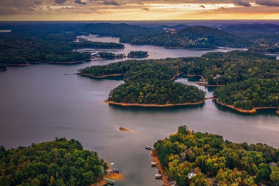 Aerial view of lush green islands on a serene lake at sunset, 1990 Sumerset 16 x 70.