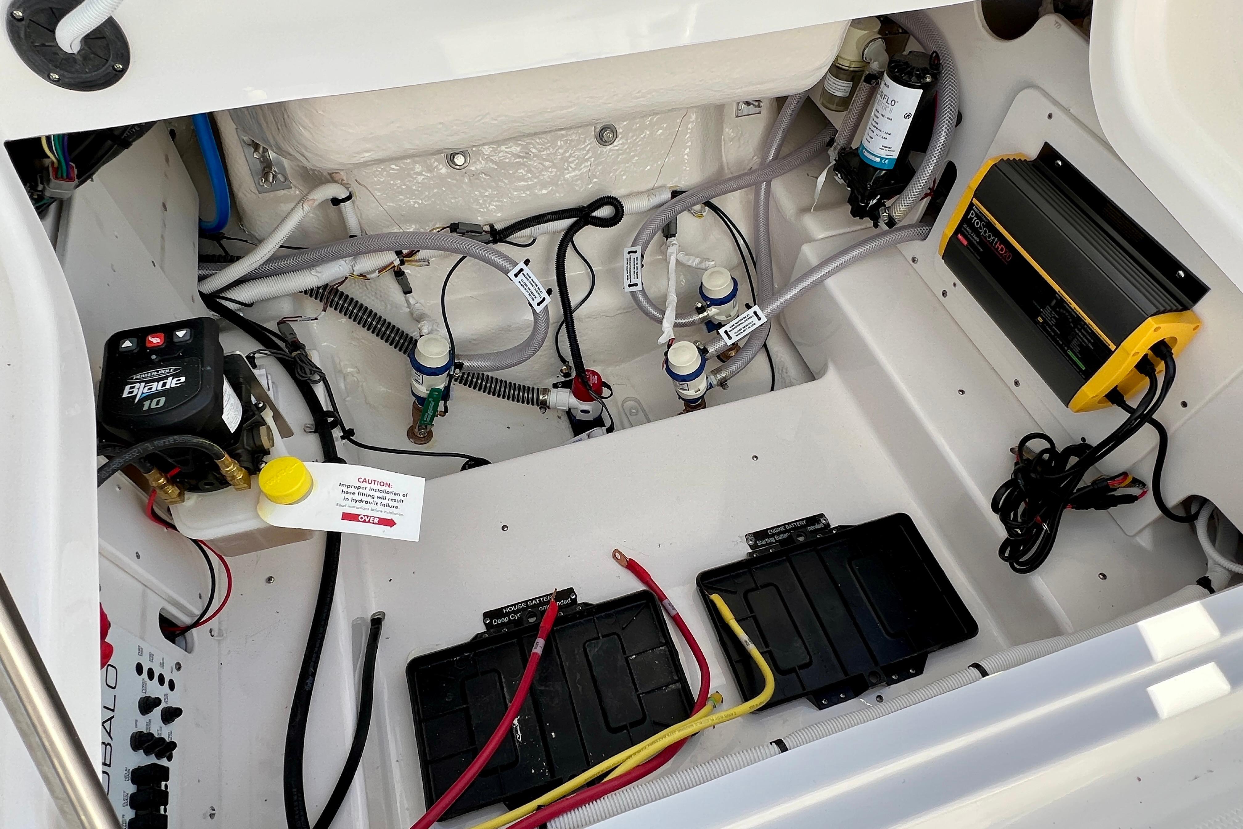 2026 Robalo 246 Cayman boat interior showing electrical and plumbing components.