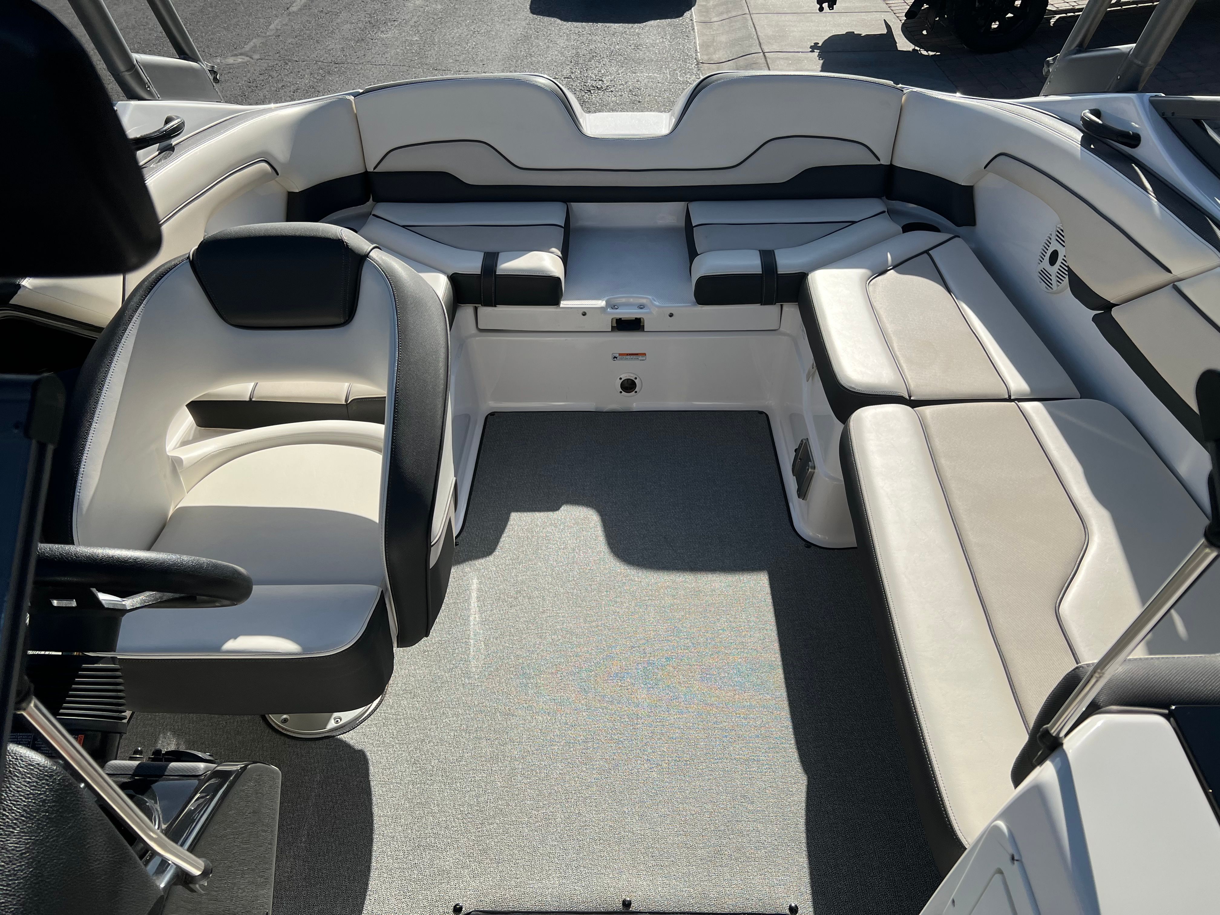 Interior of a 2018 Yamaha AR210 boat with white and black seating.