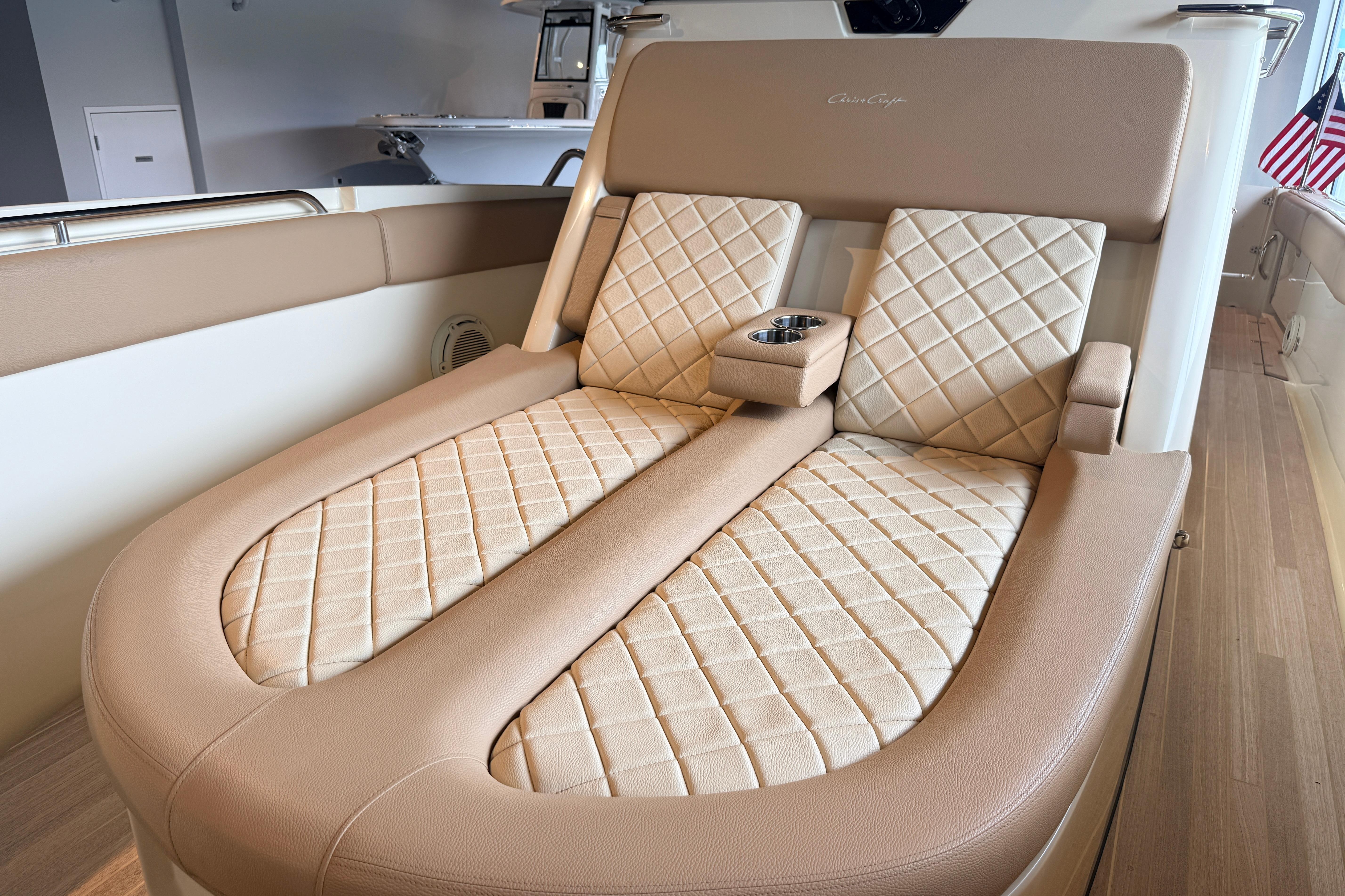 Luxurious seating on 2024 Chris-Craft Catalina 30 boat with quilted upholstery and cup holder.