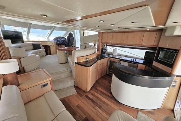Luxurious interior of a 2005 Sunseeker Manhattan 66 yacht with modern kitchen and seating area.