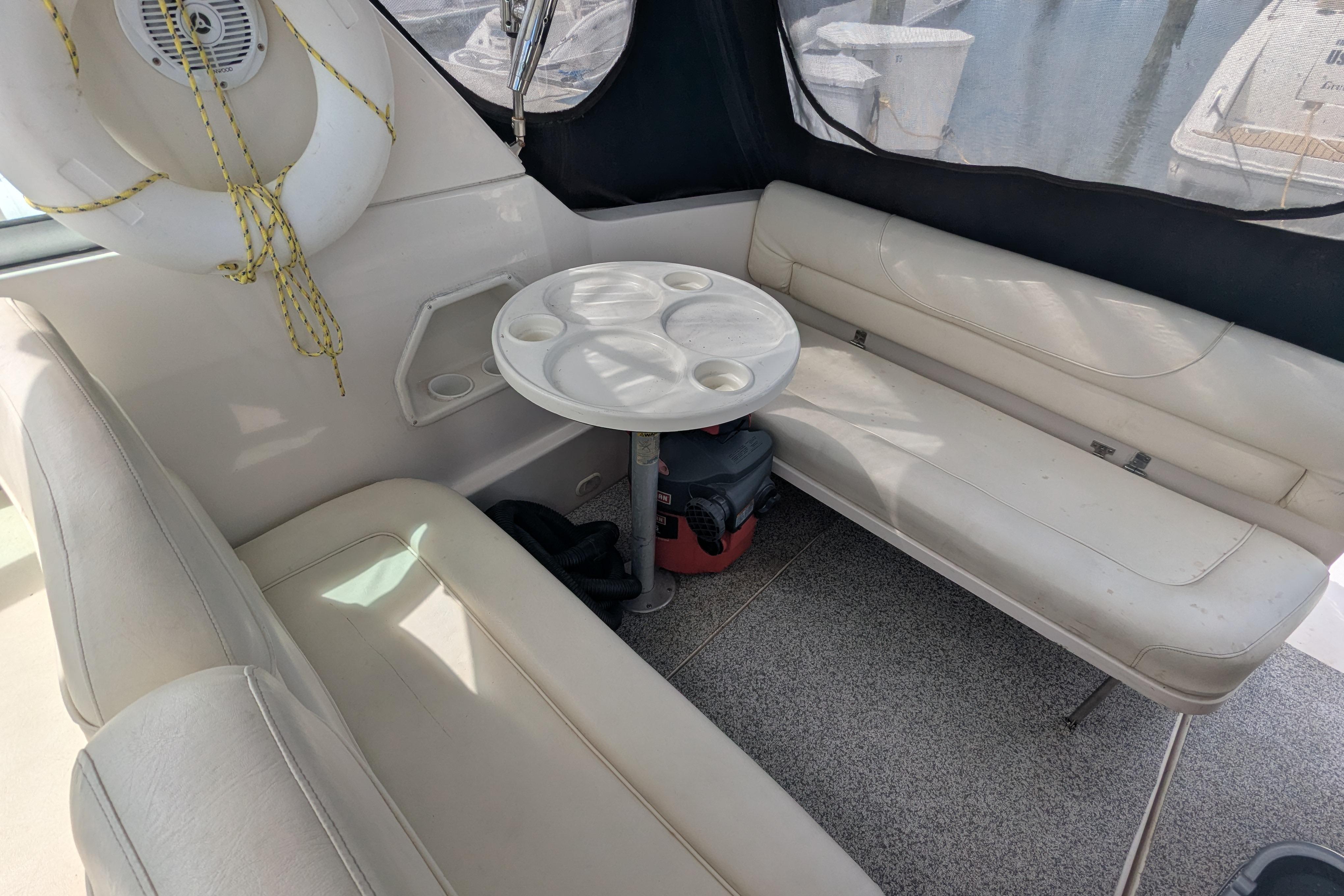 Interior of 2003 Monterey 282 Cruiser with seating, table, and life preserver.