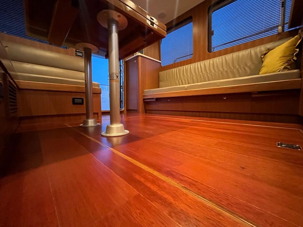Luxurious Bracewell 41 yacht interior with polished wood flooring and comfortable seating, 2025 model.