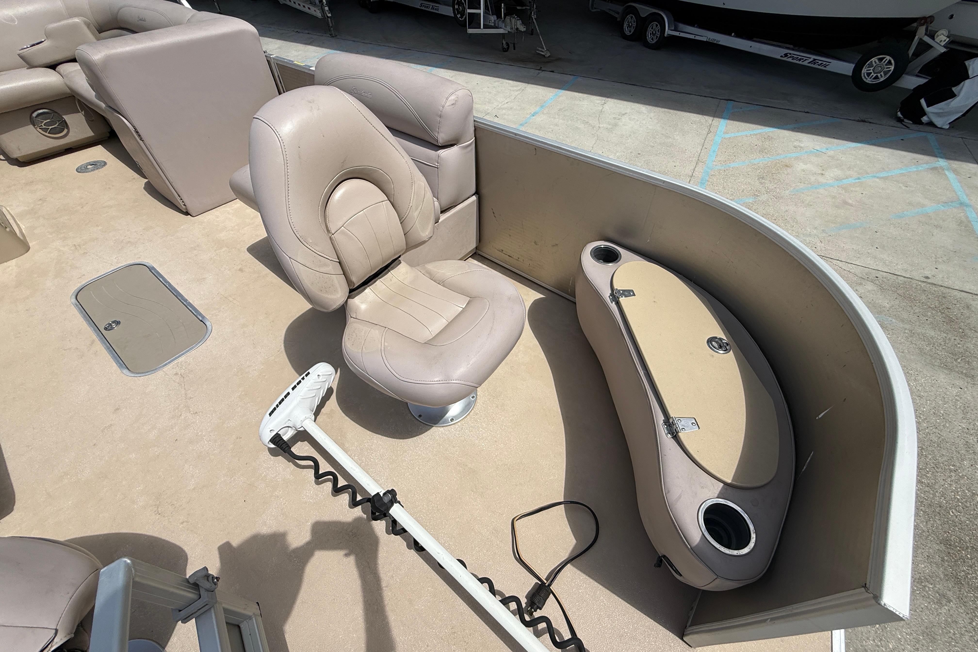 2014 Godfrey Sweetwater 2486 C boat interior with beige seating and storage compartment.