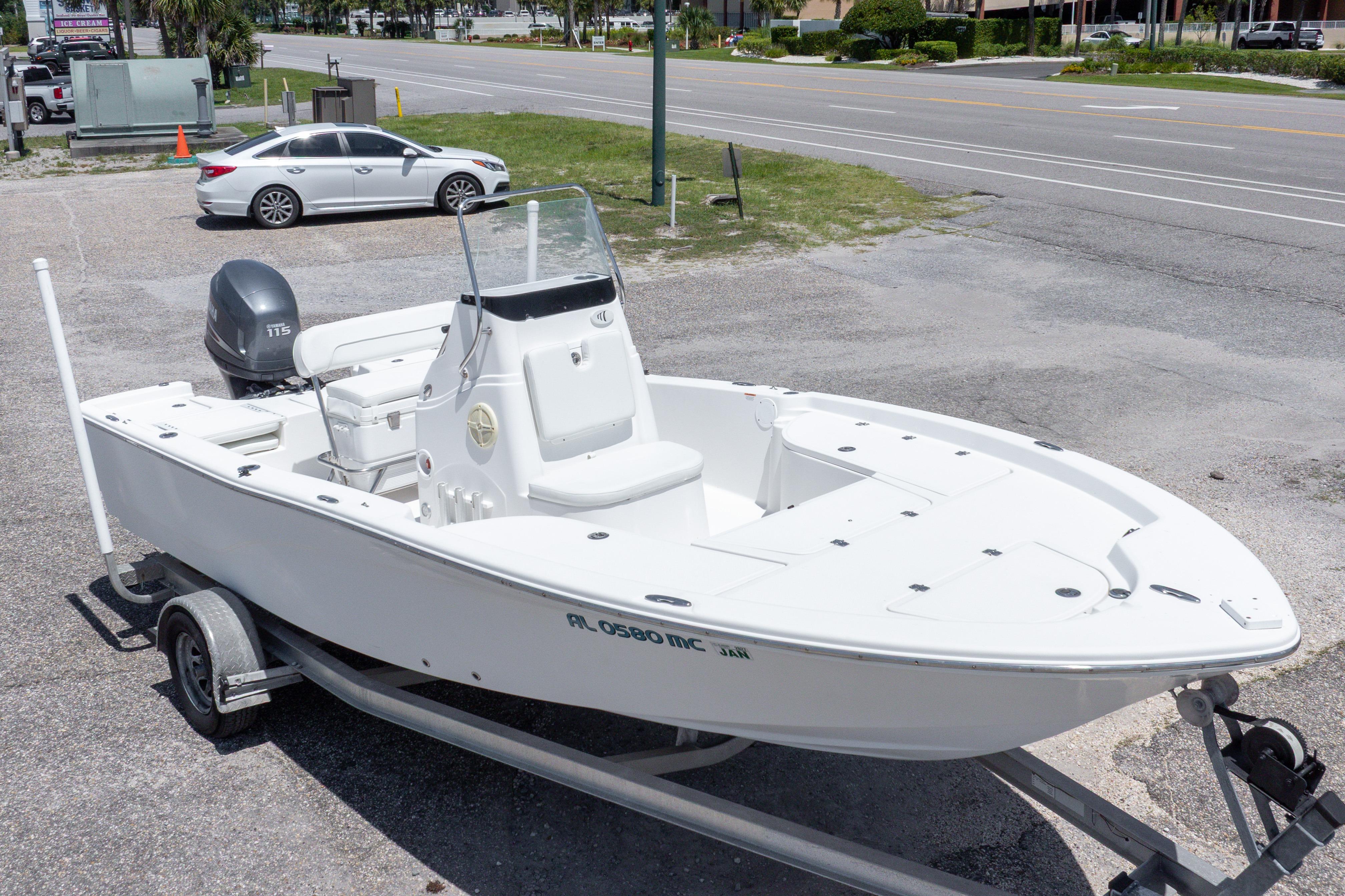 2011 Sea Fox 200XT boat on trailer, parked near a road.