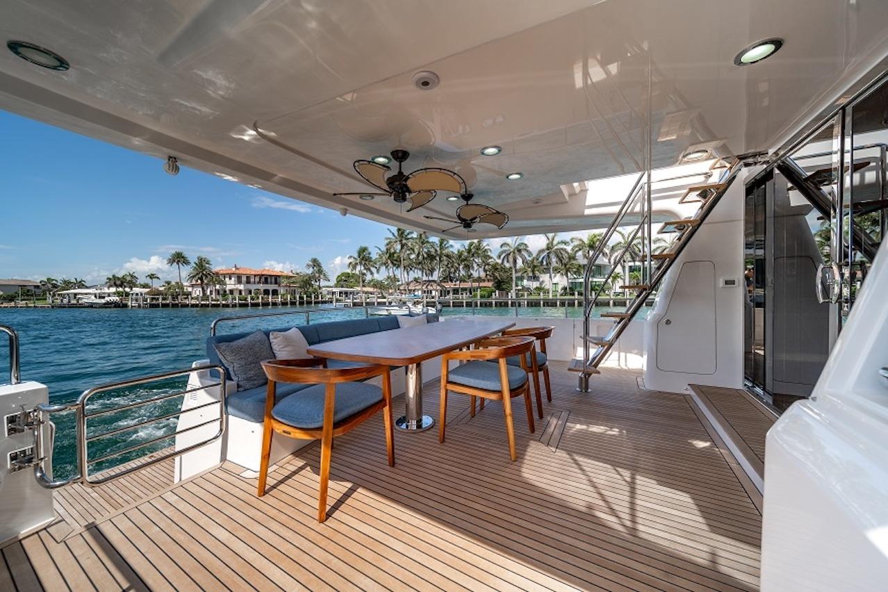Luxurious deck of 2027 Offshore Yachts 70 CE, featuring elegant seating and ocean view.