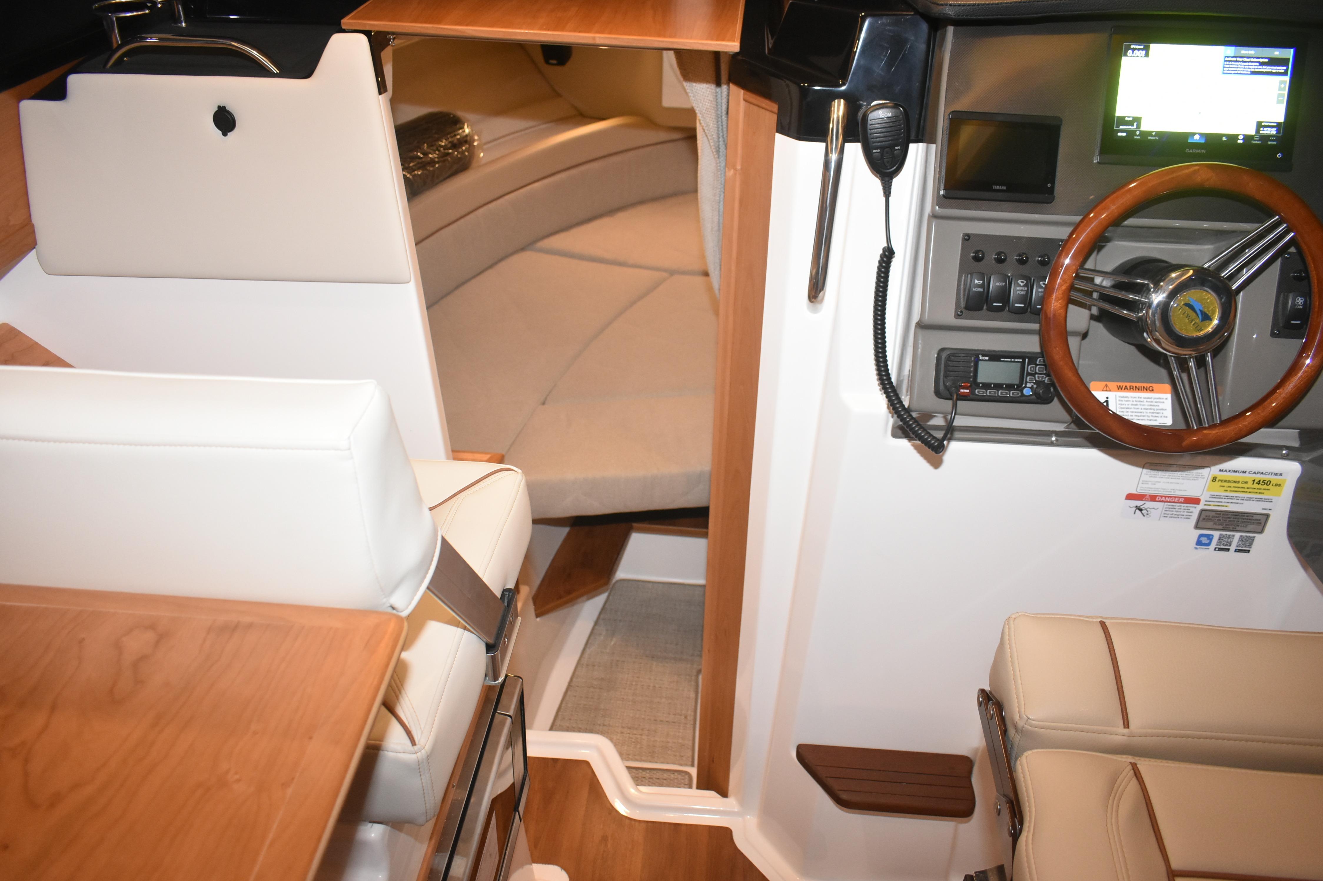Interior of 2026 Cutwater C-248 Coupe, featuring helm and seating area.