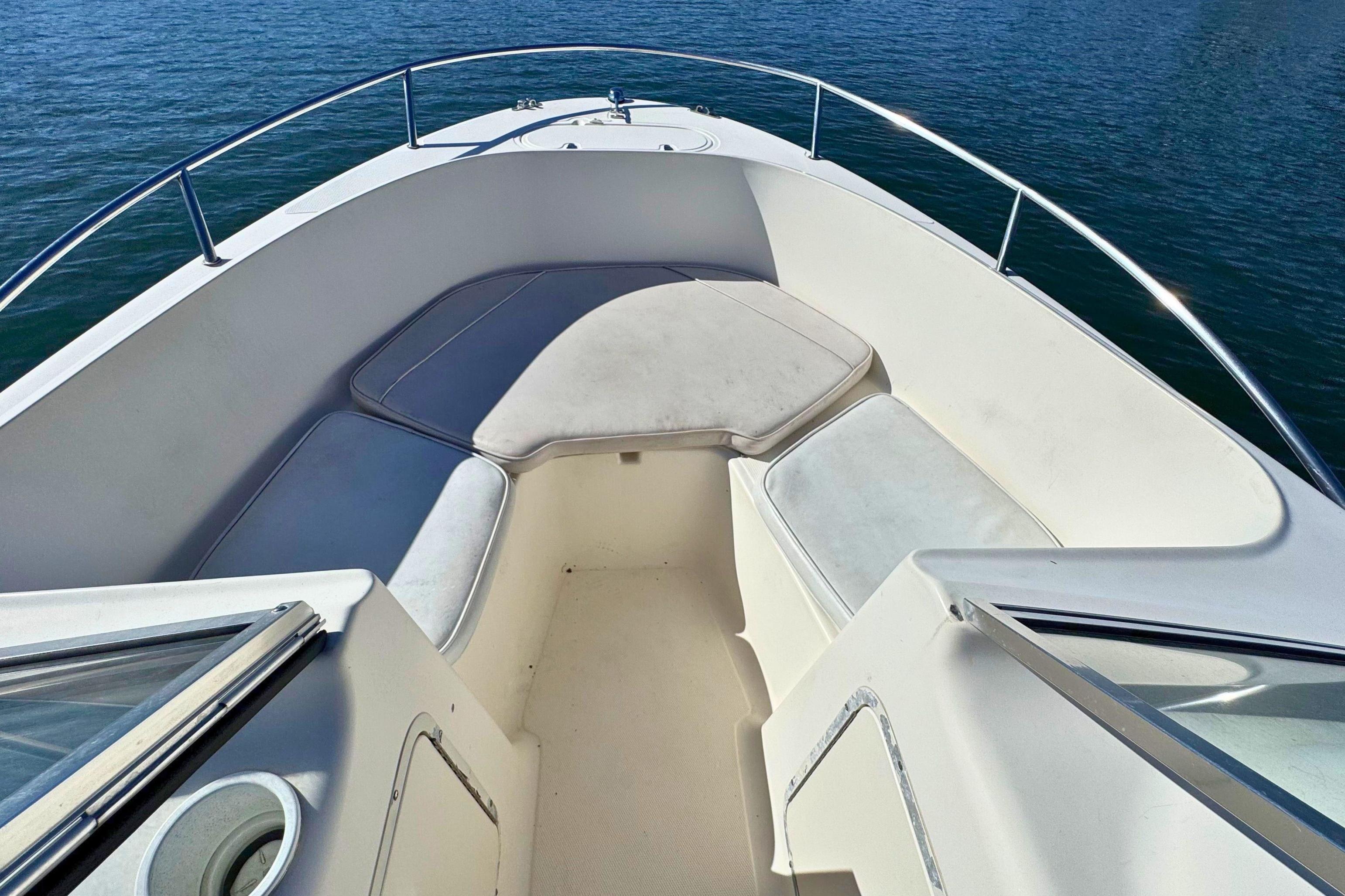 2002 Sea Hunt Escape 200 boat interior with cushioned seating, surrounded by calm water.