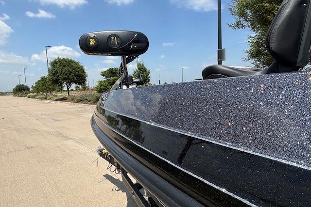 2026 Ranger 212LS boat with glittery finish, parked outdoors under a clear blue sky.