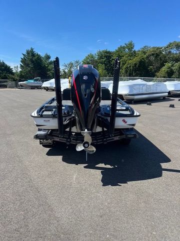 2026 Bass Cat Cougar FTD SP boat, rear view, parked outdoors on sunny day.