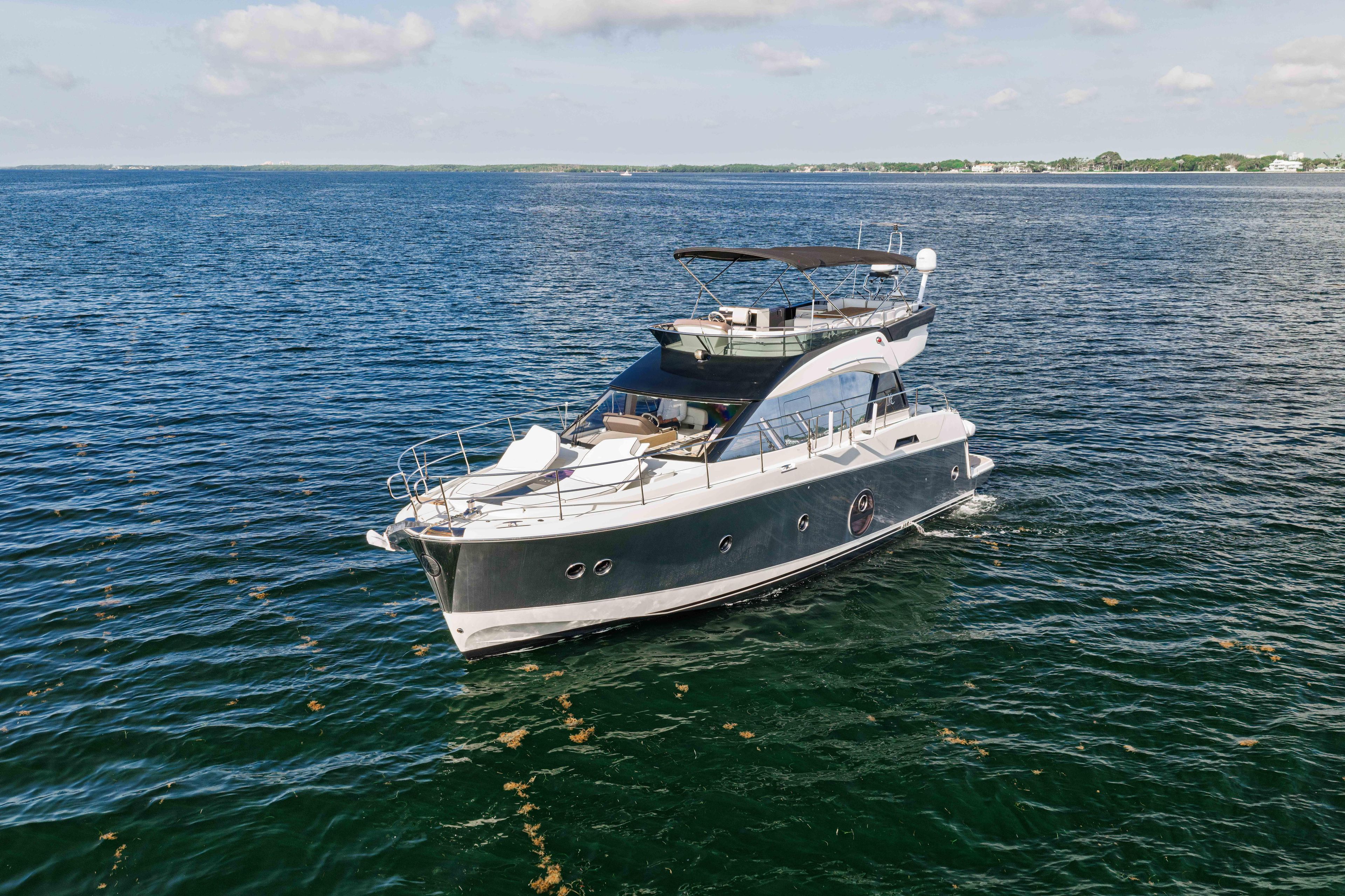 2017 Monte Carlo Yachts MC5 cruising on open water under a clear sky.