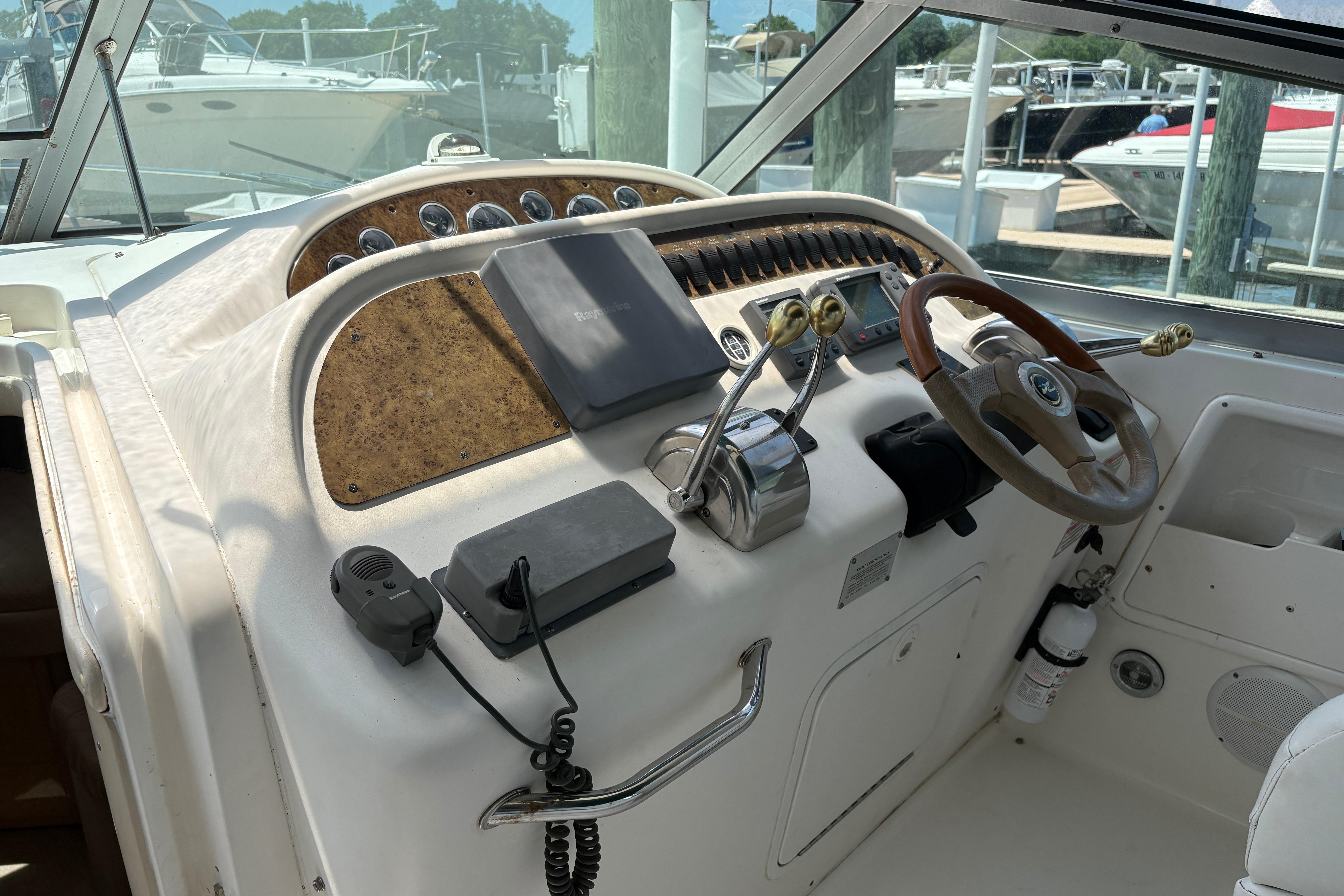 Cockpit of 2001 Sea Ray Sundancer 310 with steering wheel and control panel.