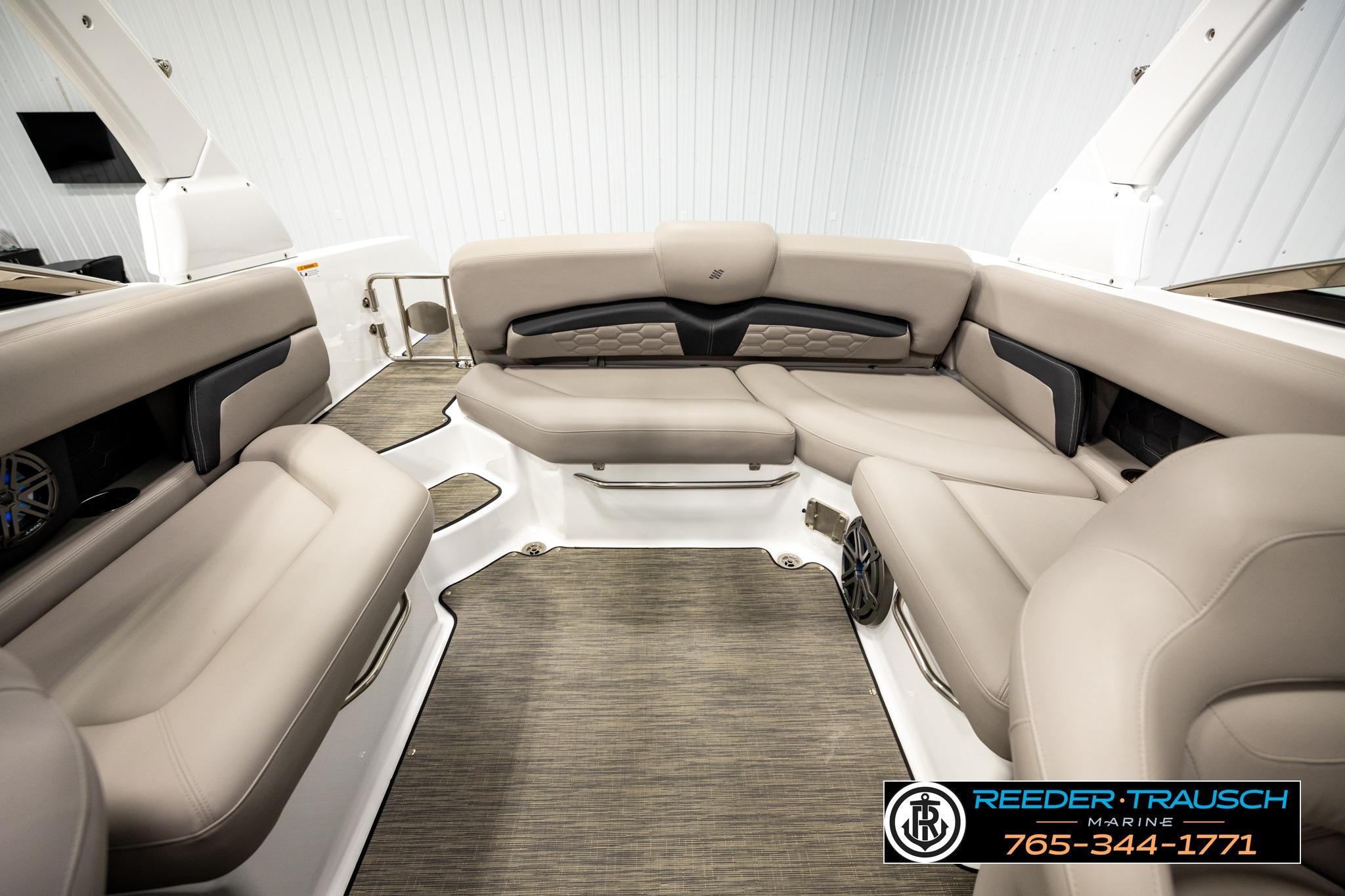 2024 FOURWINNS HD5 Surf boat interior with beige seating and modern design.