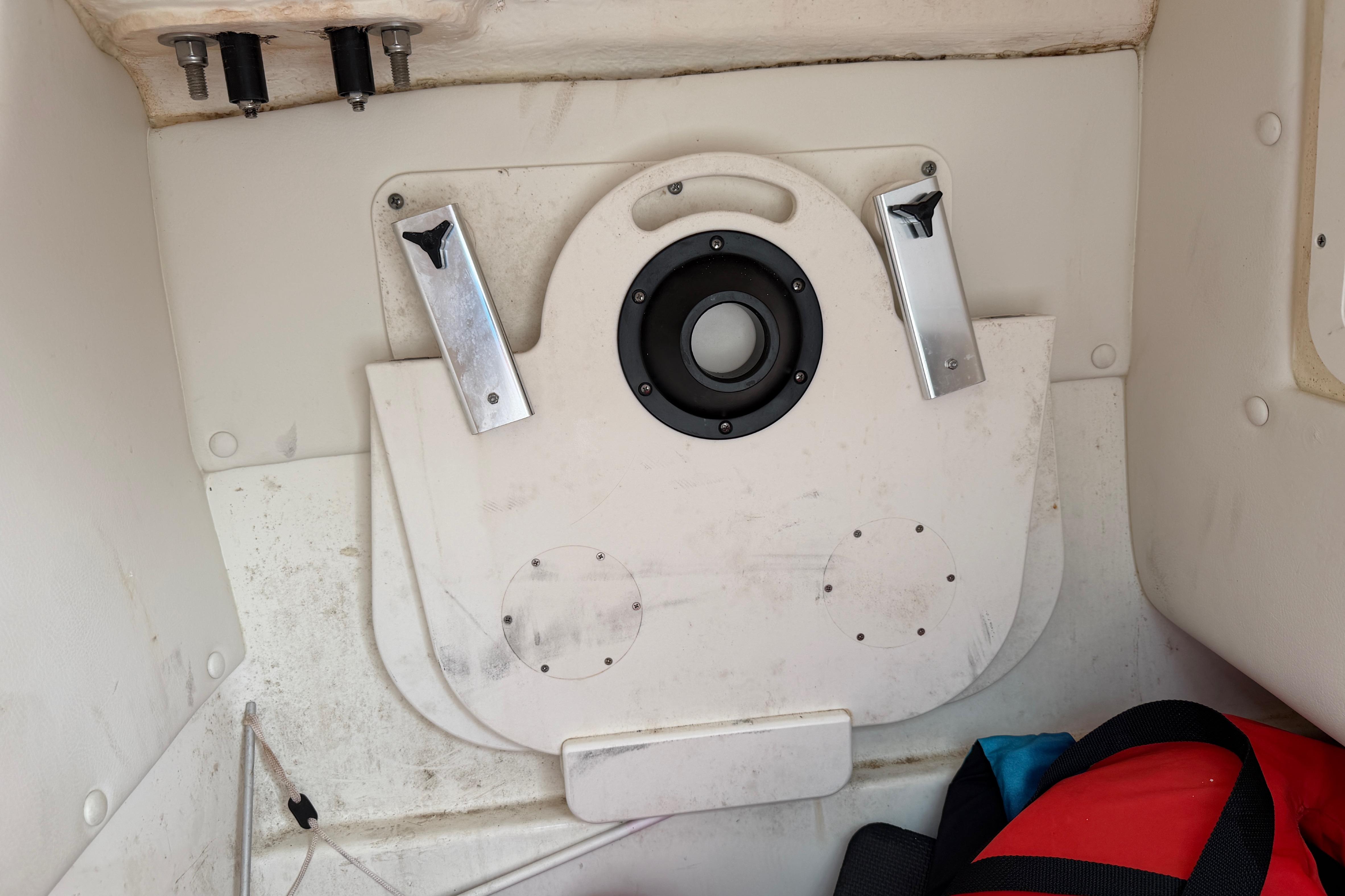 Interior view of a 2019 World Cat 230 DC boat compartment with storage features.