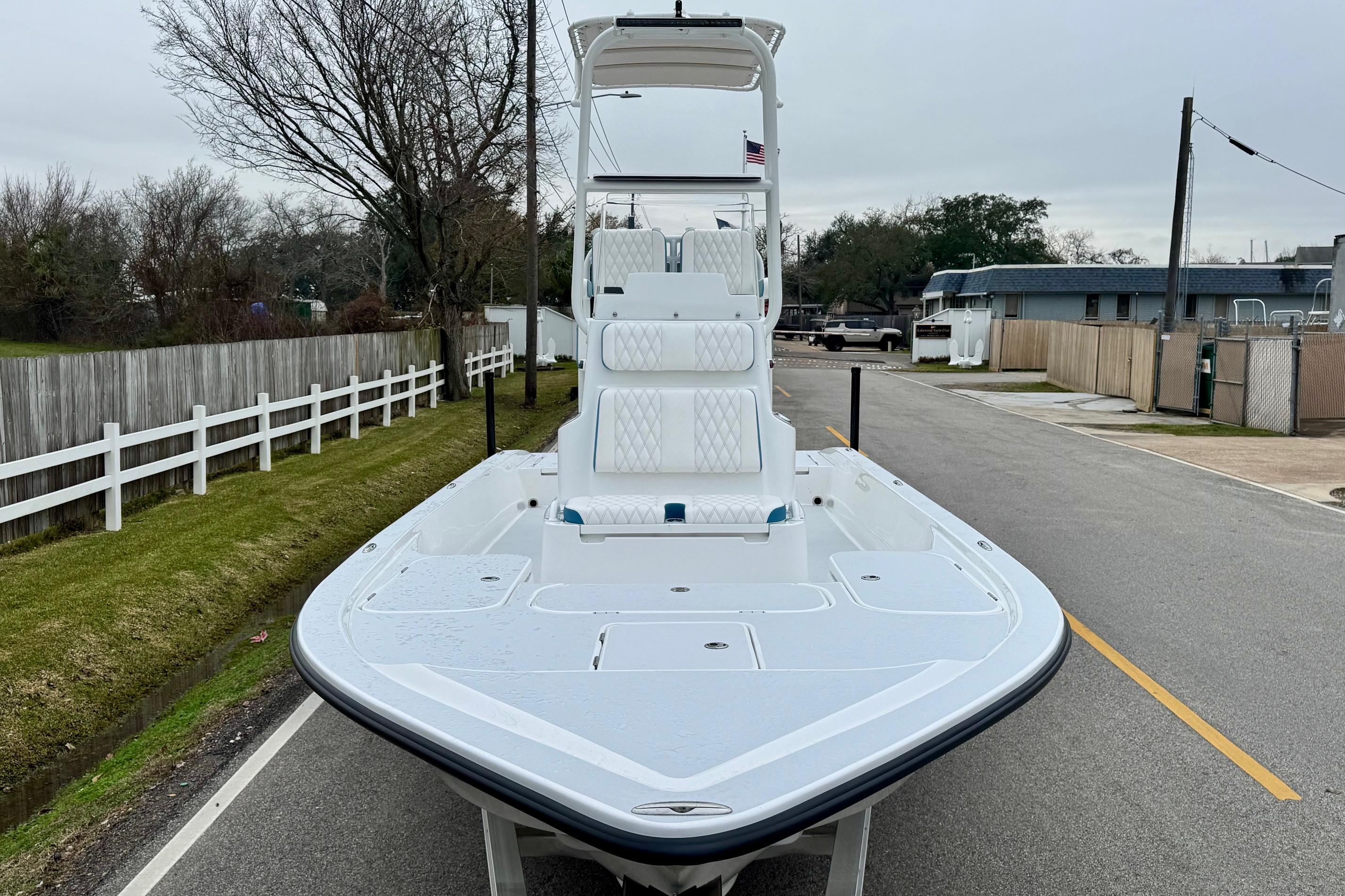2026 Shallow Sport 24 Modified V boat on a street, showcasing sleek design and spacious deck.