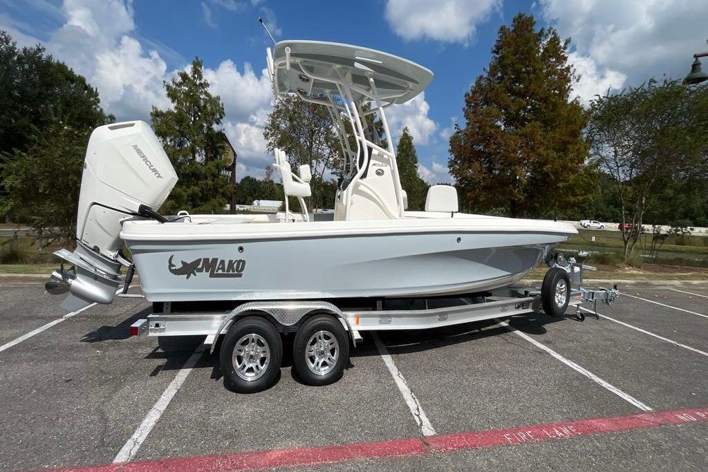 2026 Mako 24 APEX boat on trailer, parked outdoors under a blue sky.