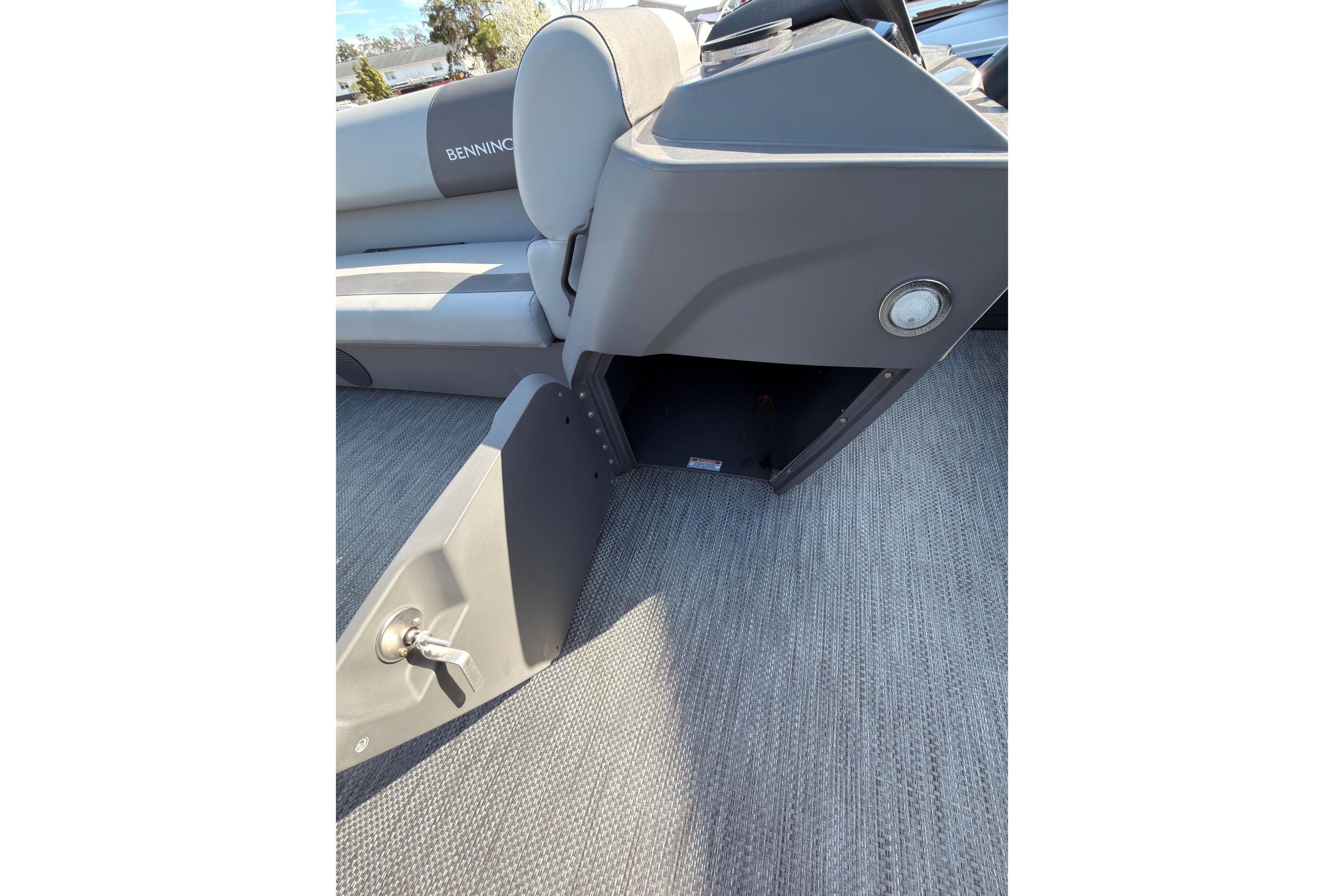 2024 Bennington SVL boat interior with open storage compartment and seating.