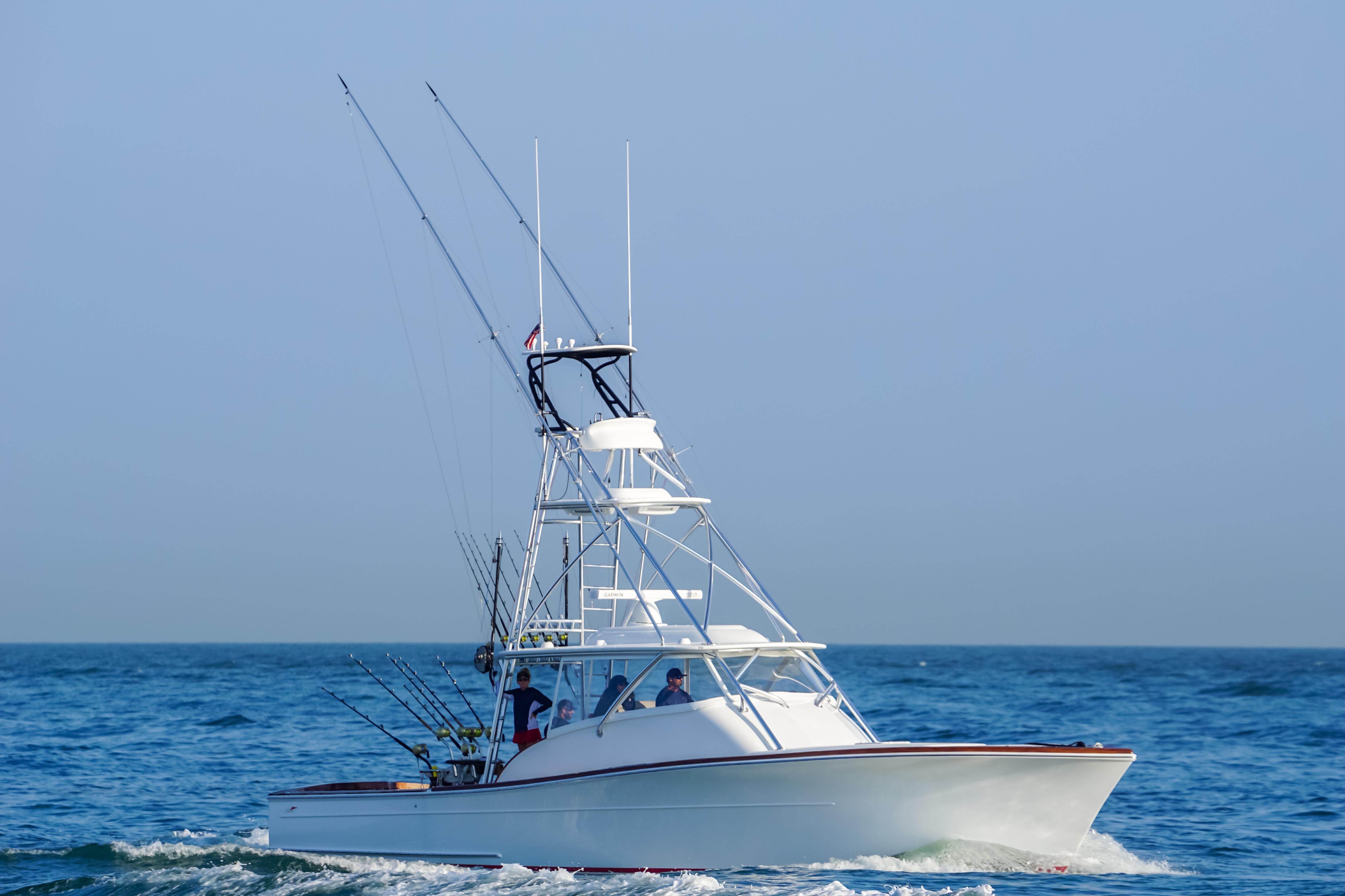 2026 Release Boatworks 46 Walkaround cruising on open sea under clear blue sky.