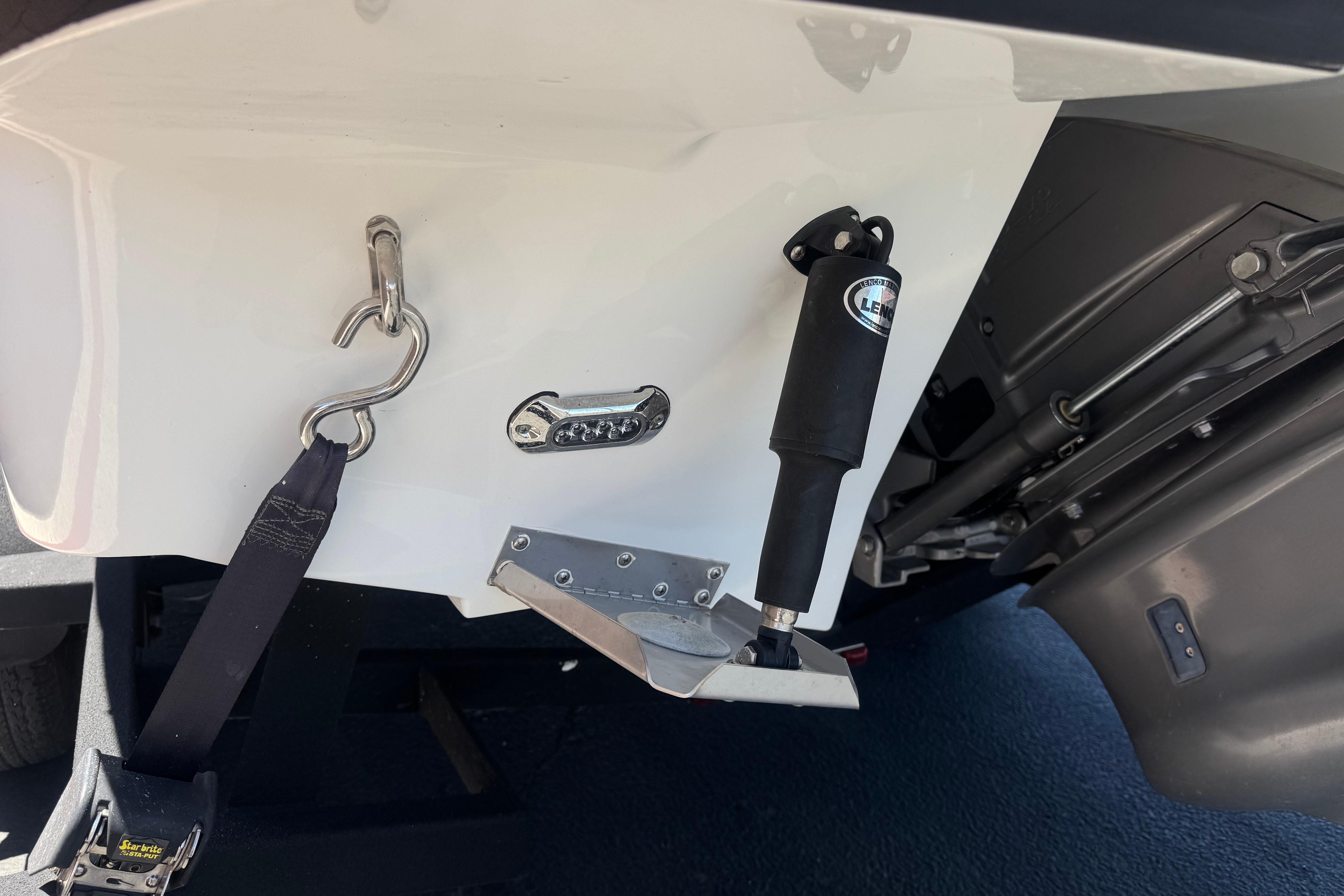 Close-up of 2022 Four Winns H4 boat's stern with trim tab and hardware.