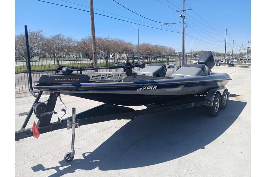 1994 Gambler 21 boat on trailer, parked outdoors under clear blue sky.