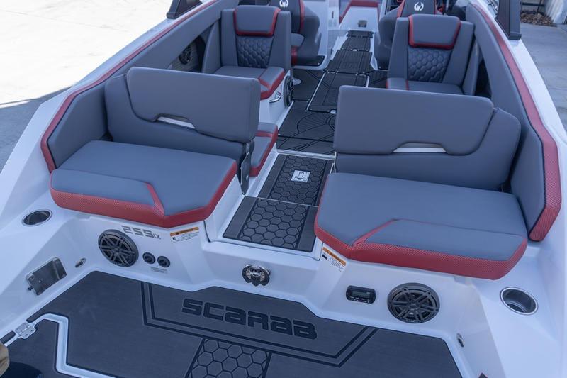 2026 Scarab 255 LX Wake boat interior with gray and red seating.