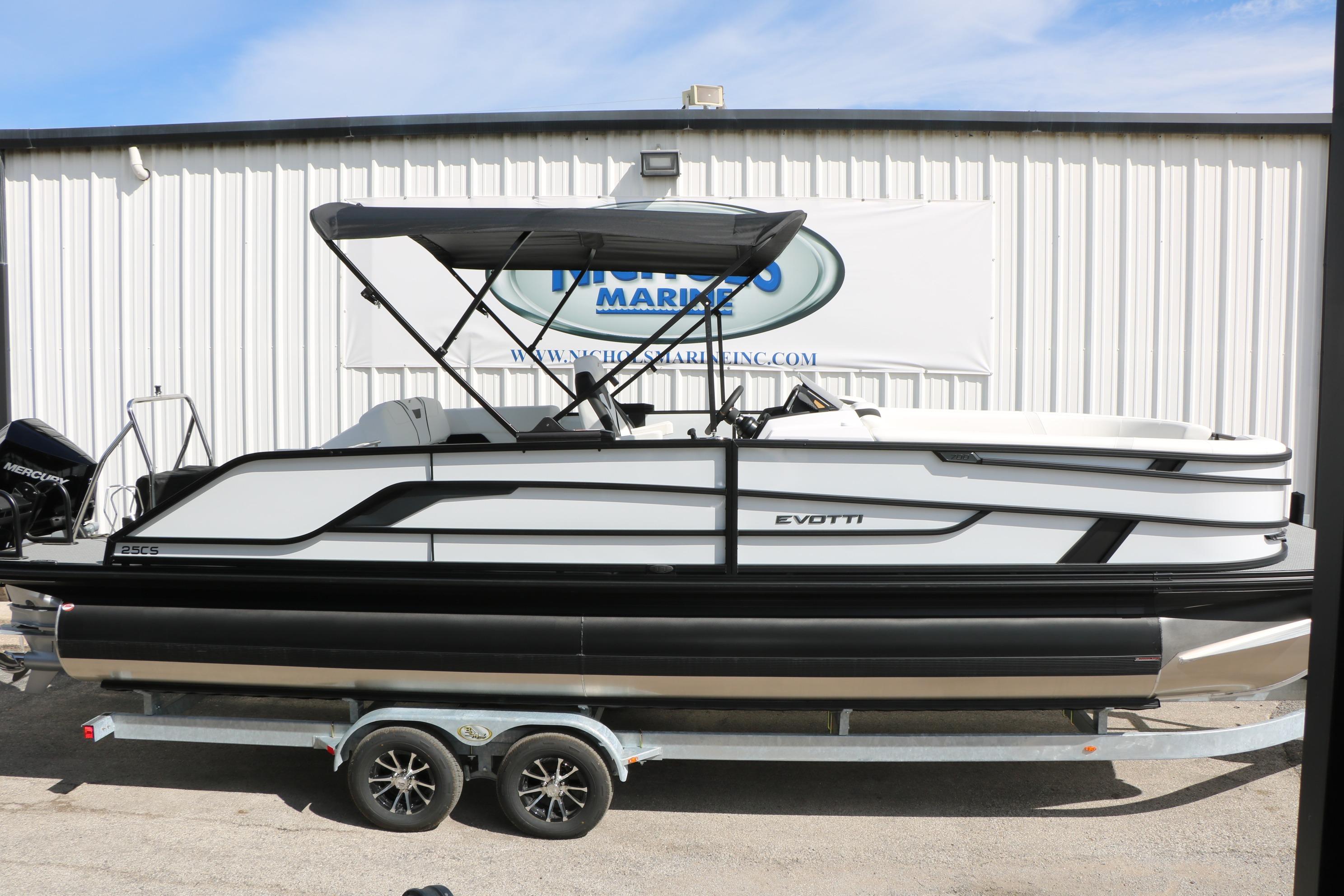 2026 Evotti 725 CS Tri-Toon boat on trailer, side view, at marina.