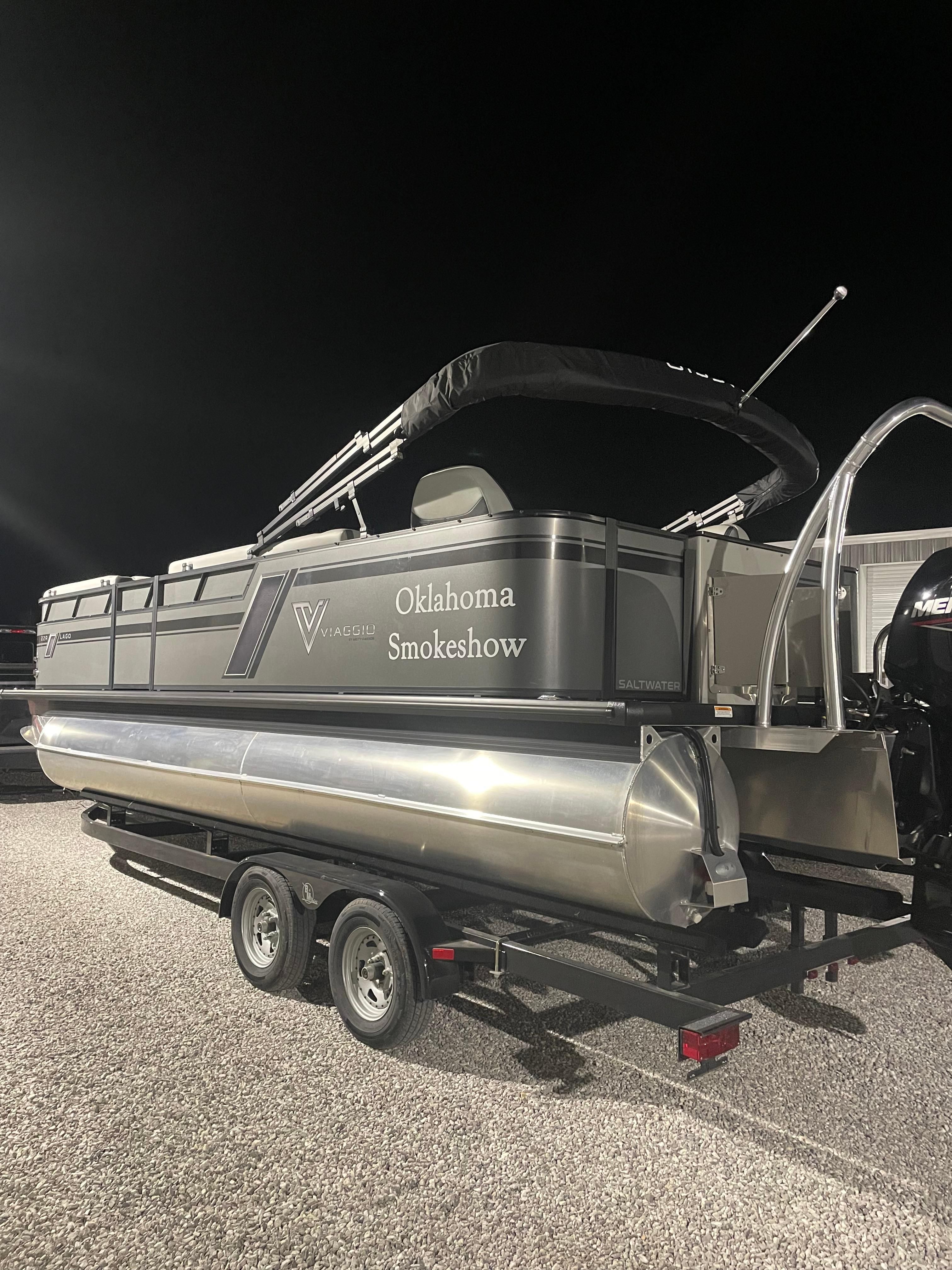 2022 Viaggio Lago pontoon boat on trailer at night, labeled "Oklahoma Smokeshow."