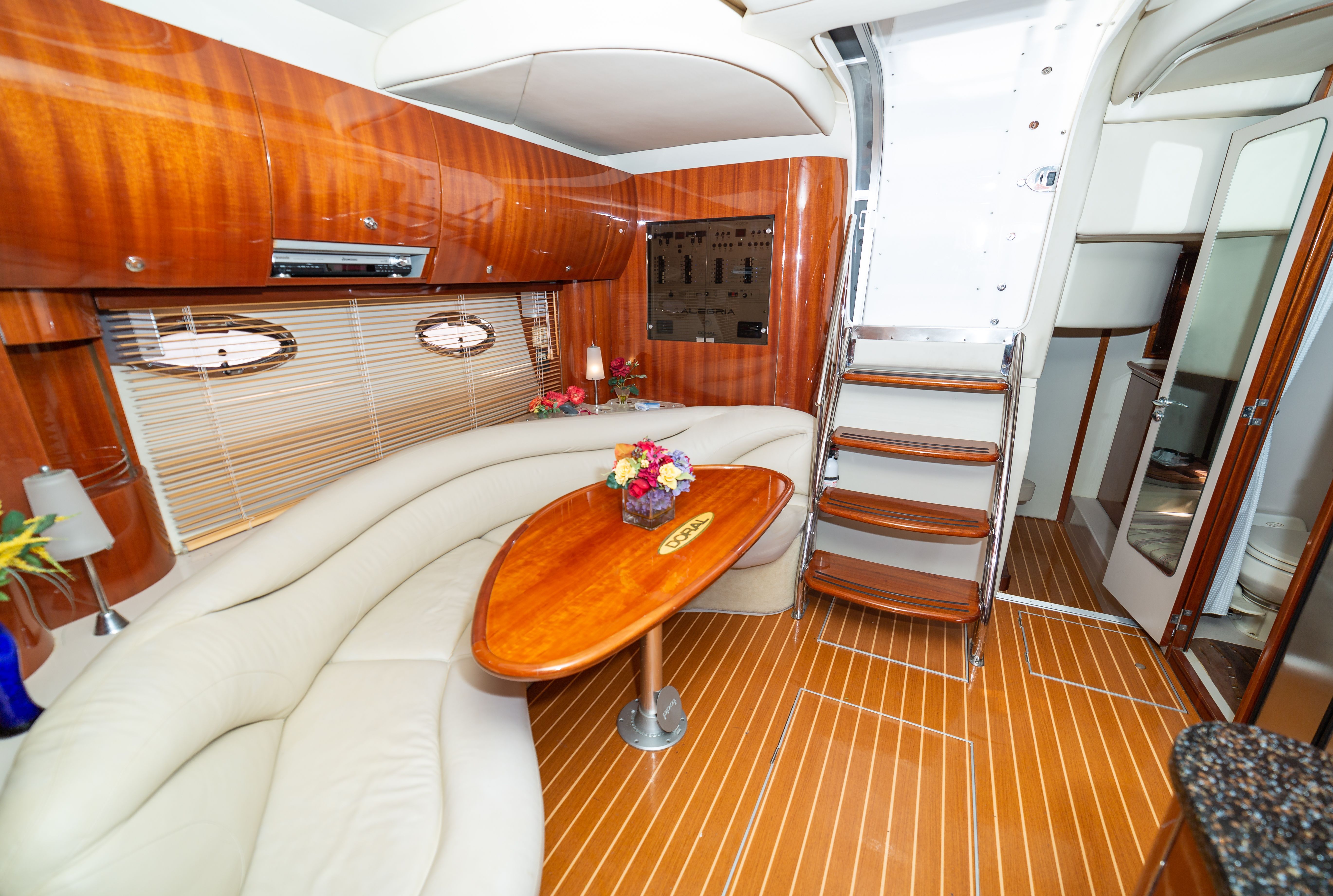 Interior of a 2004 Doral Alegria with elegant wood paneling and beige sofa.