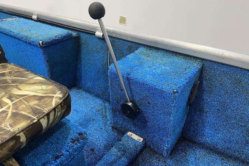 2006 SCANDY WHITE 1310 boat interior with blue carpet and camo seat.