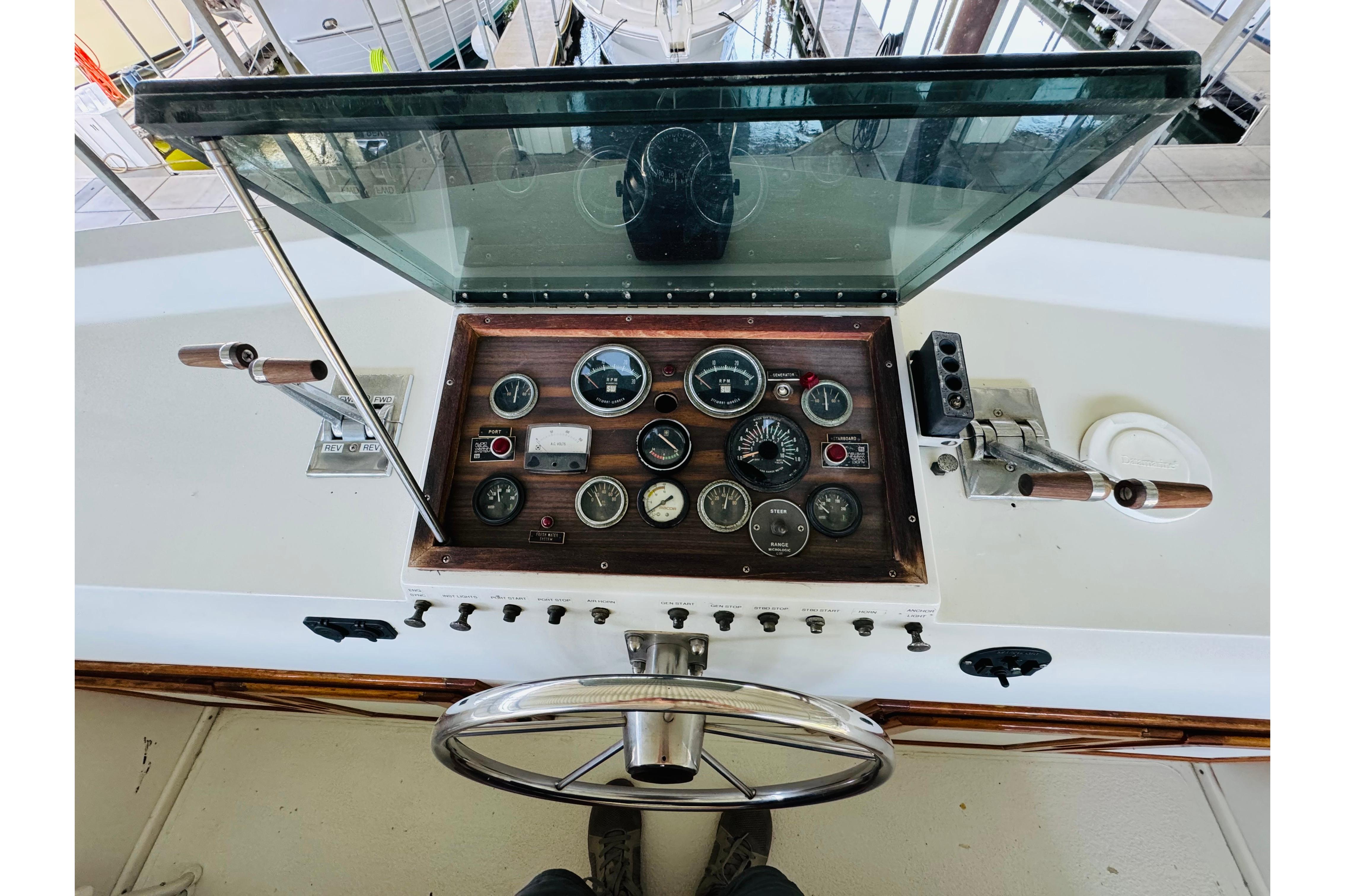 1978 Californian 42 LRC helm with vintage gauges and controls, featuring a wooden dashboard.