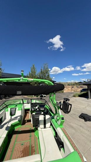 Green 2018 Nautique Super Air Nautique G23 boat with white interior.