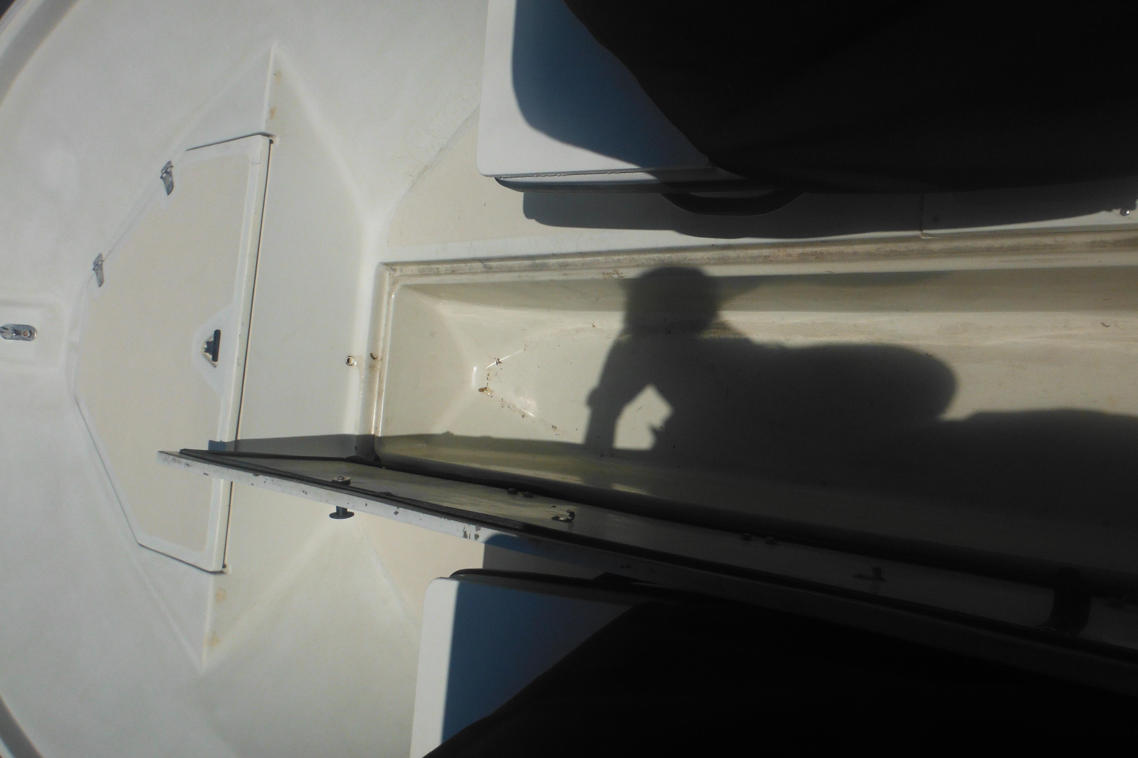 1991 Boston Whaler 16 SL boat interior with shadow on deck.