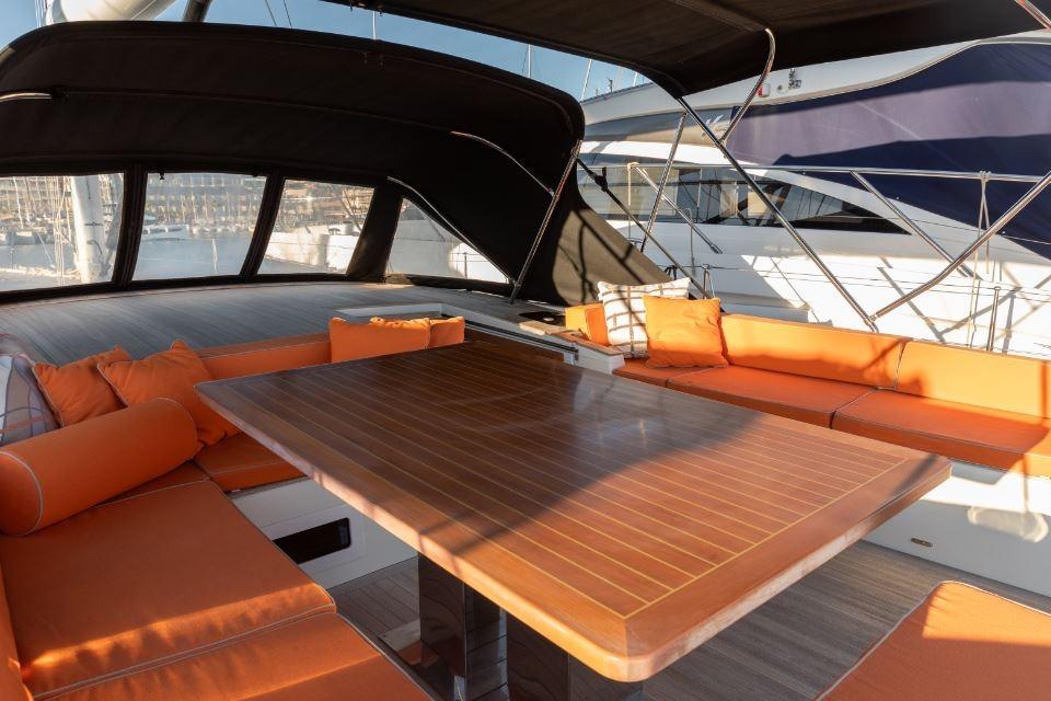 Luxurious 2022 Solaris 64RS yacht with elegant outdoor seating and wooden table.