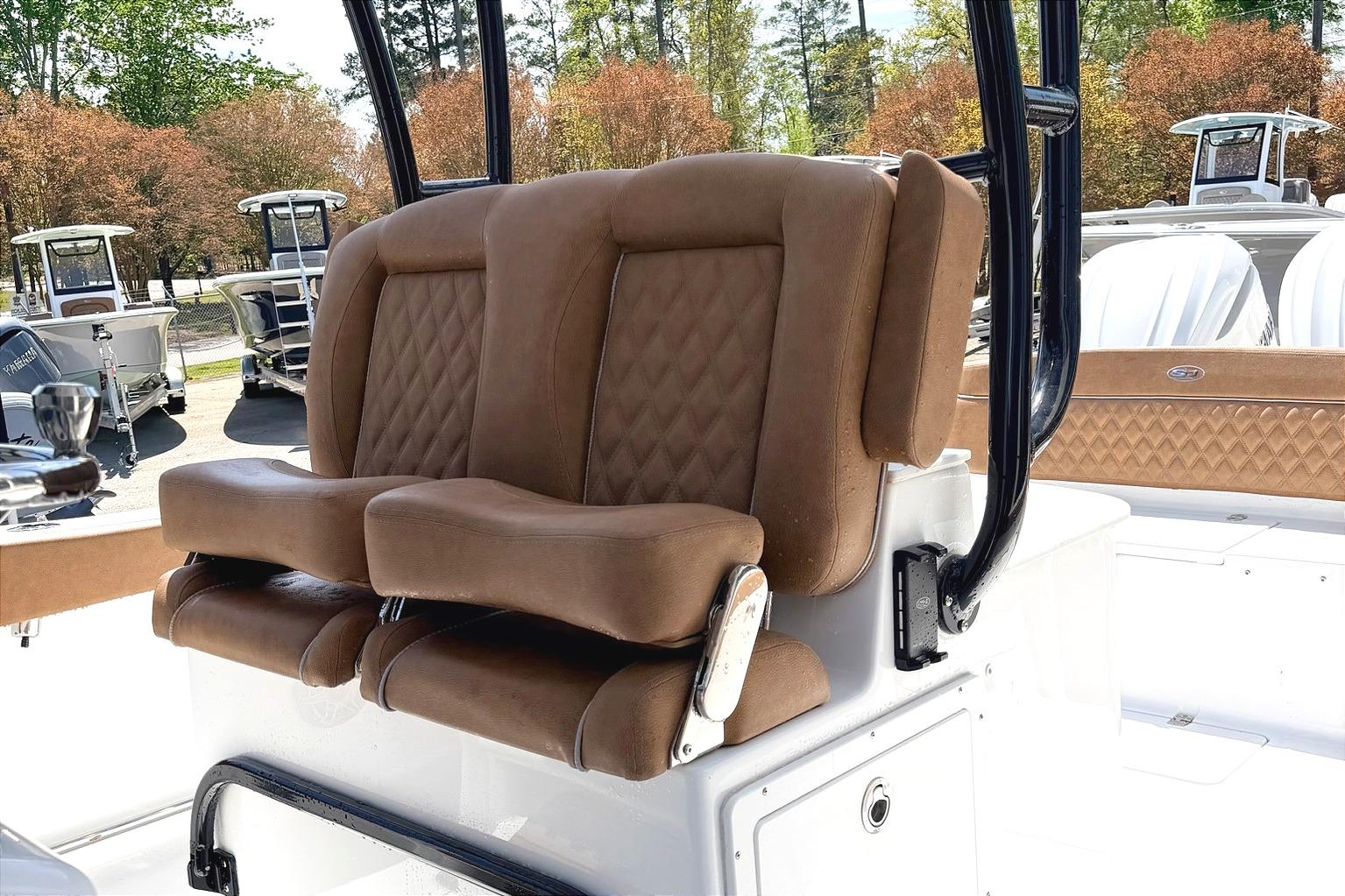 2026 Seahunt Ultra 305 CB boat with luxurious brown seating and sleek design.