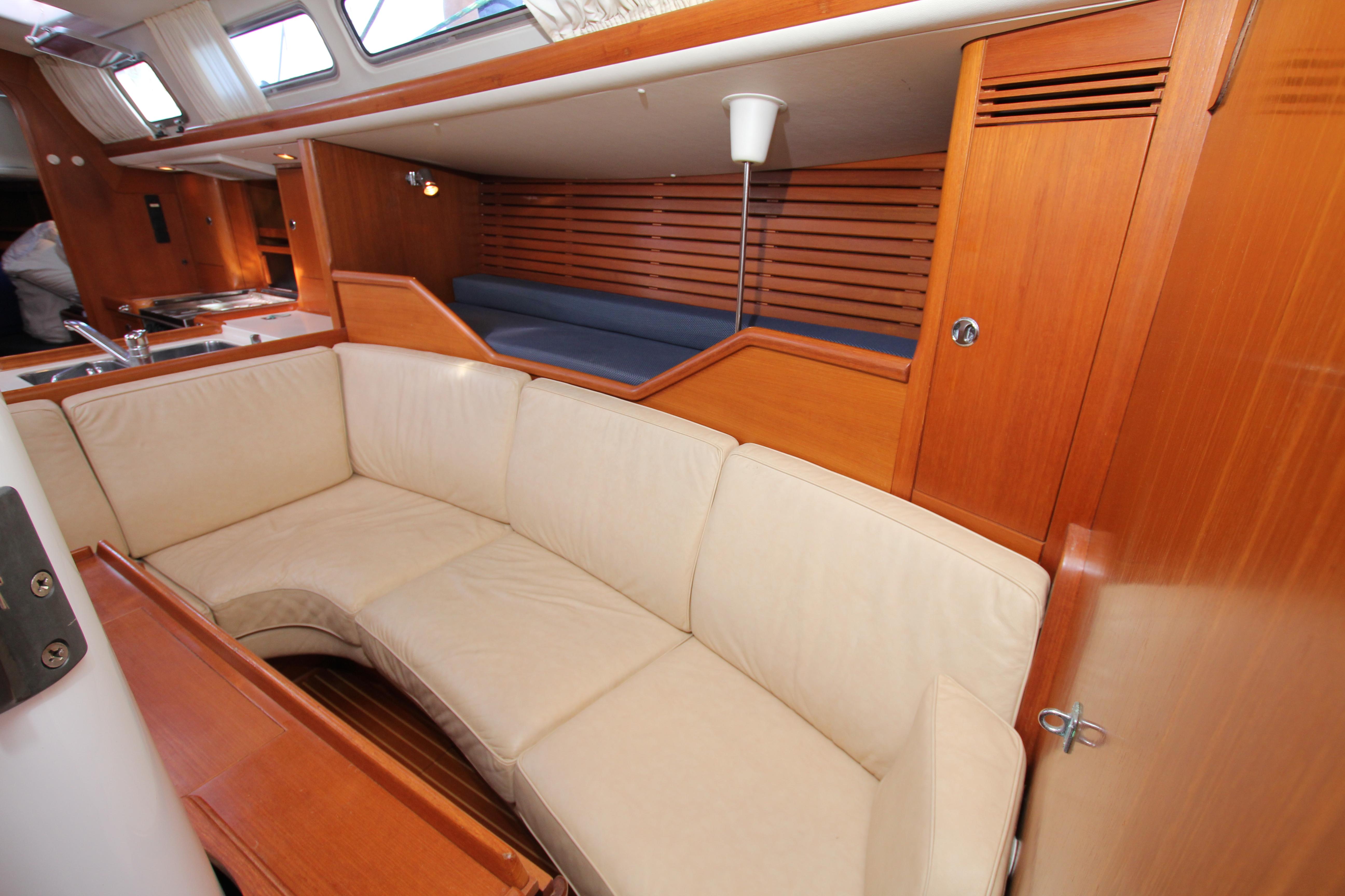 Interior of 2001 Nautor Swan 44MKII yacht with beige seating and wooden finishes.