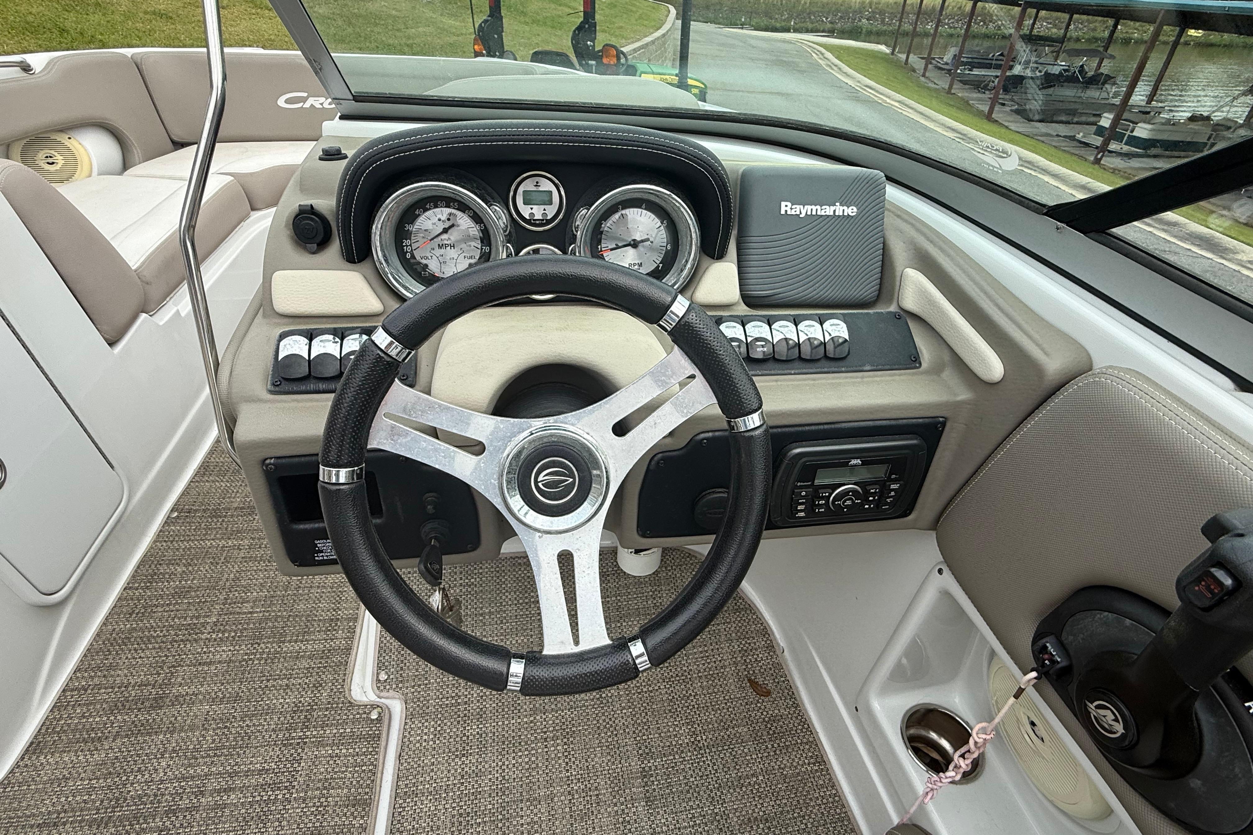 2017 Crownline Eclipse E1 XS boat dashboard with steering wheel and Raymarine equipment.