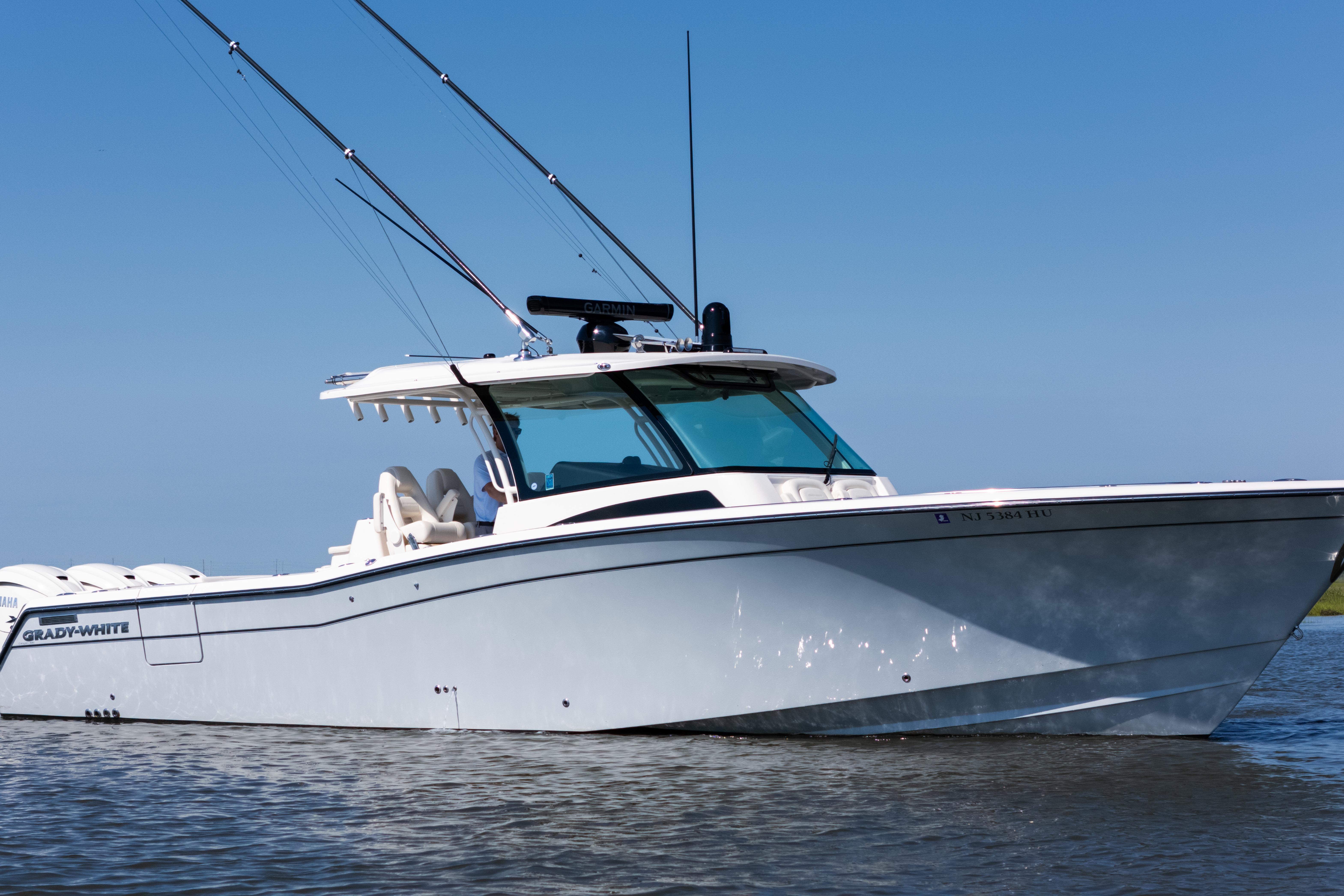 2025 Grady-White Canyon 386 boat on water, featuring sleek design and fishing rods.