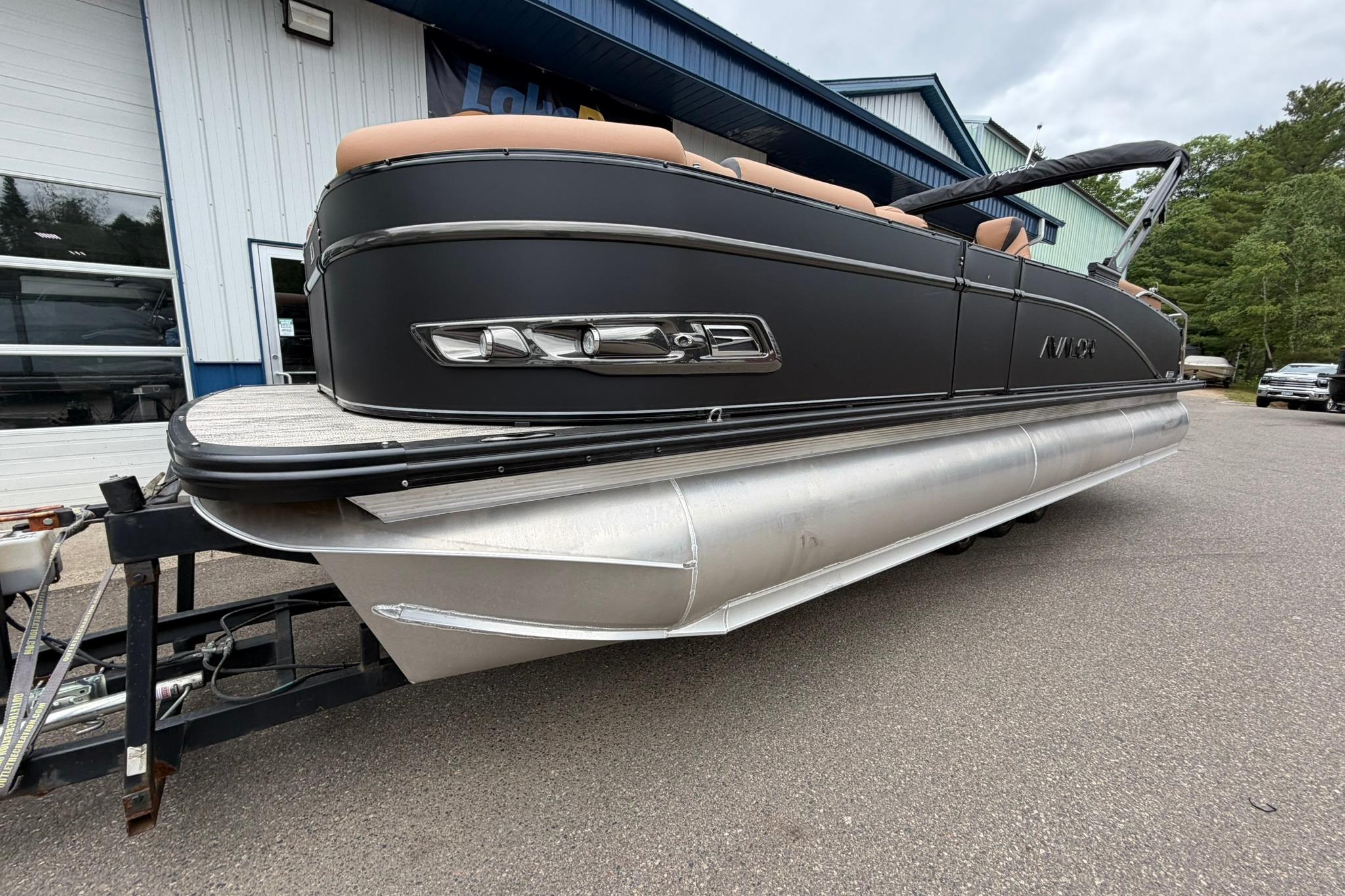2026 Avalon Catalina Quad Lounge Shift pontoon boat on trailer, parked outdoors.