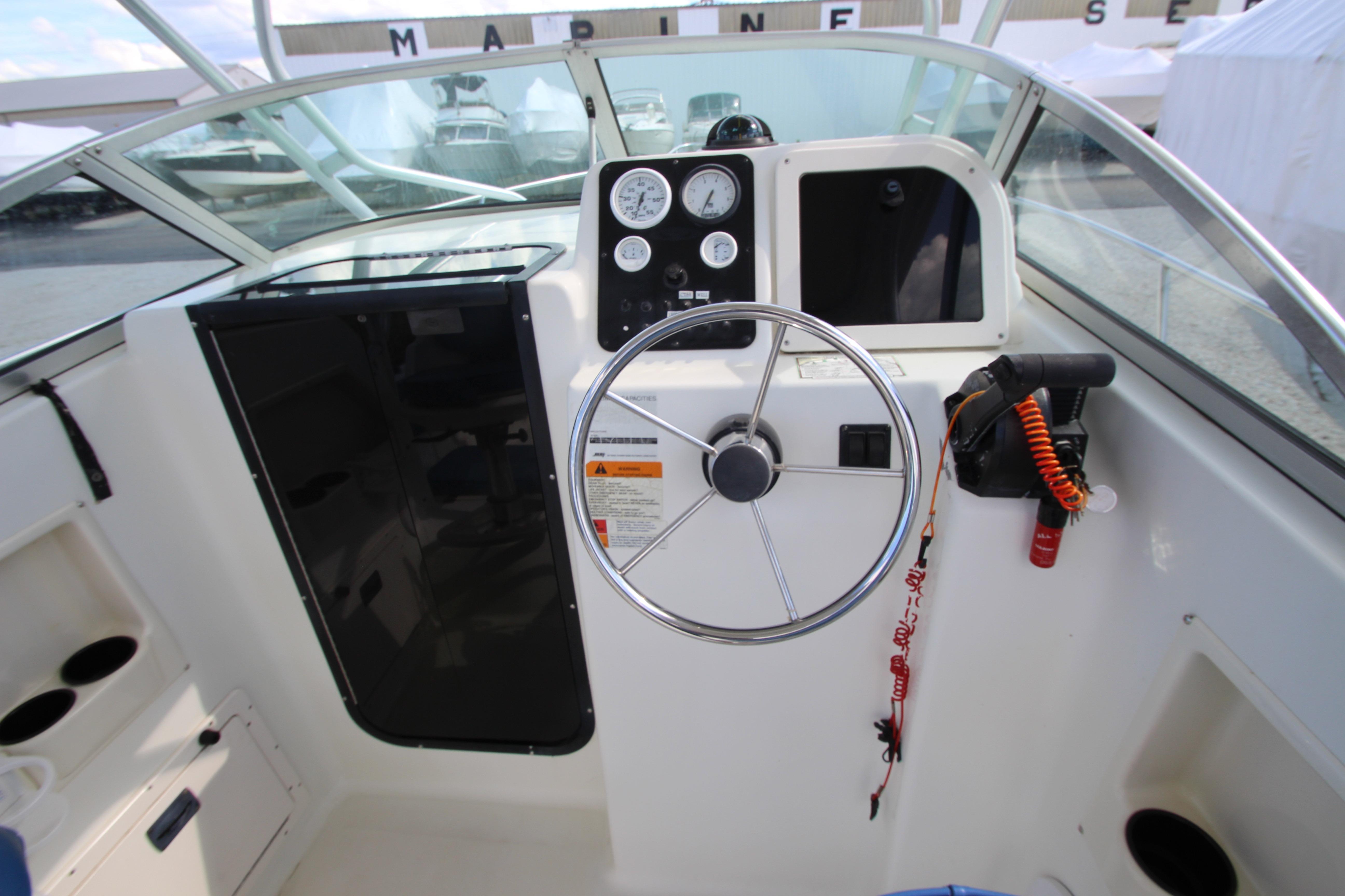 2002 Hydra-Sports 230 WA boat cockpit with steering wheel and control panel.