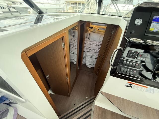 Interior of a Jeanneau NC 1095 with cabin and helm station.