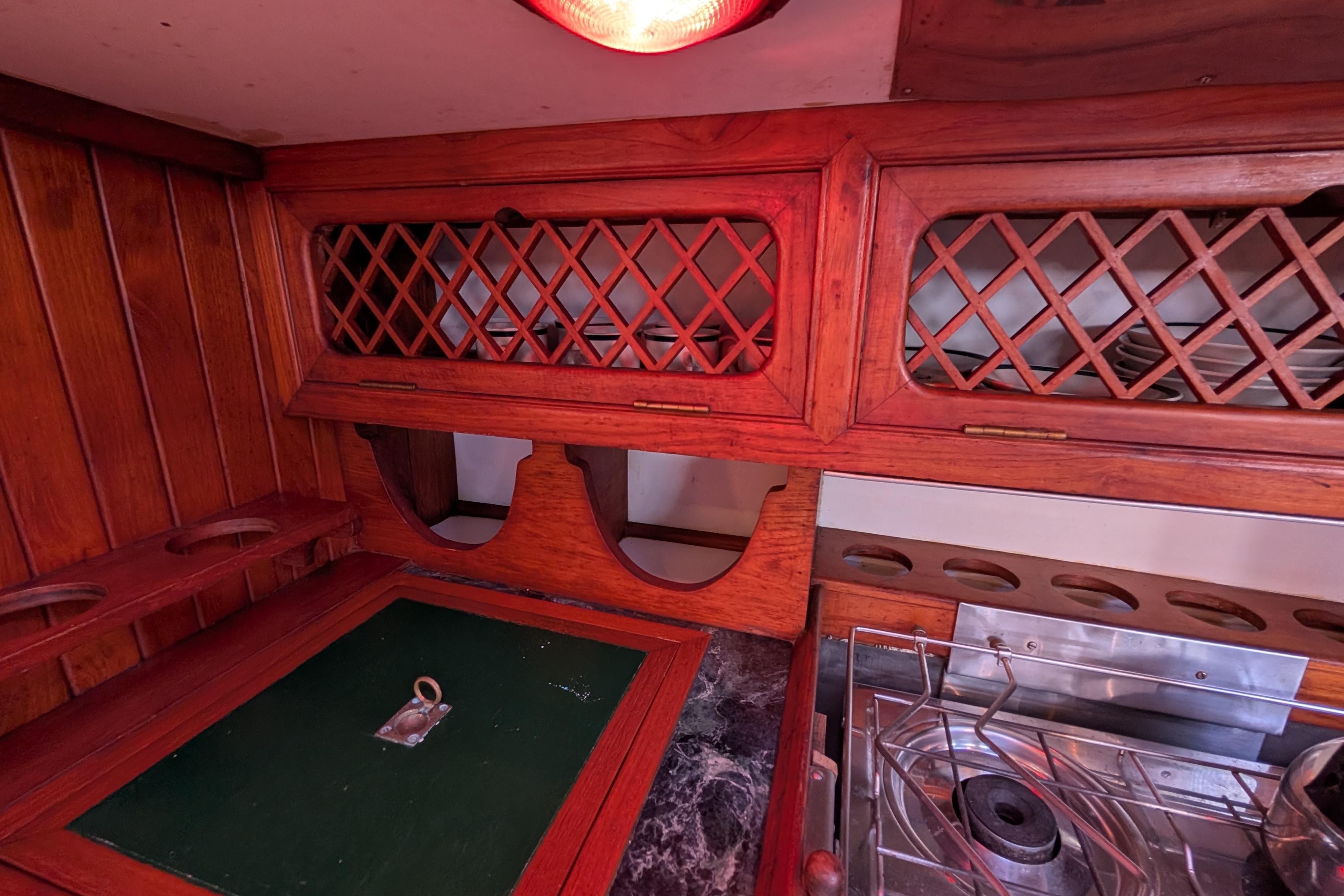 1983 Robert Perry 41 yacht interior with wooden cabinetry and stove.